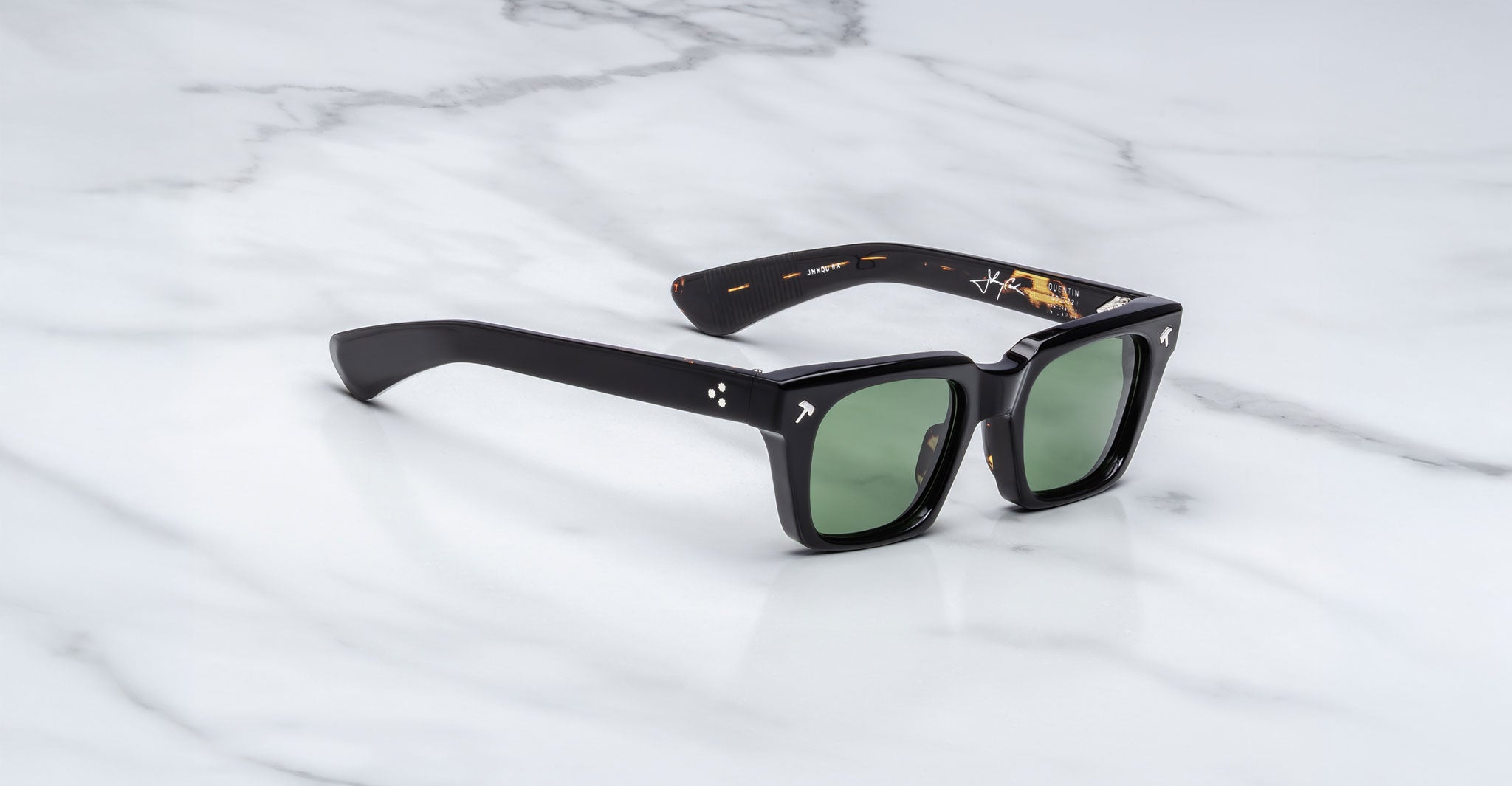 Jacques Marie Mage Quentin black rectangular sunglasses with green lenses, top view.