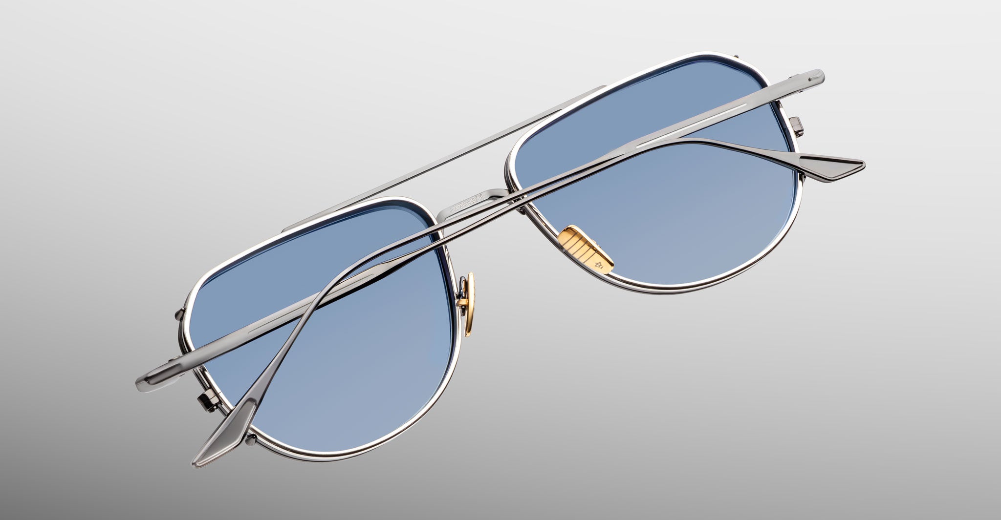 Jacques Marie Mage Cendrars aviator sunglasses with blue lenses and silver frames, front view.