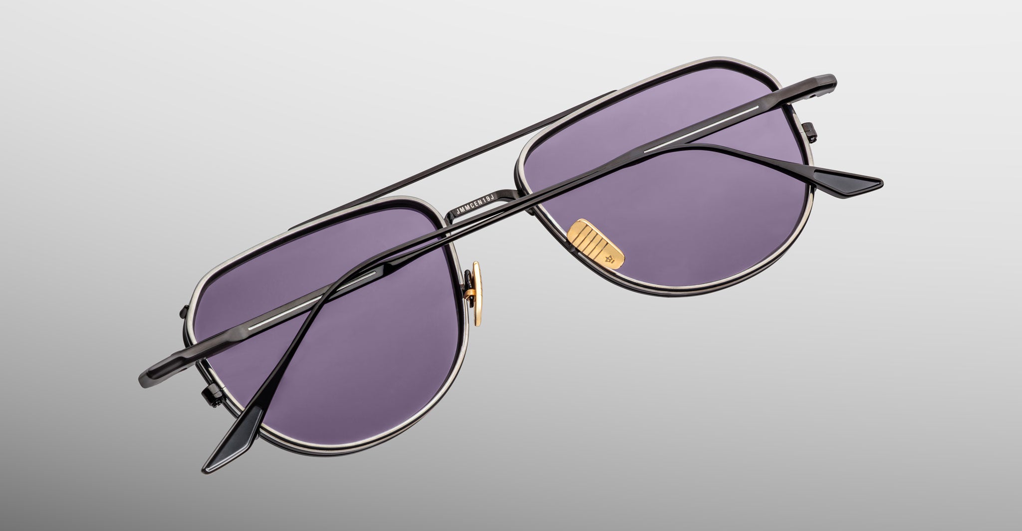 Jacques Marie Mage Cendrars aviator sunglasses, black frames, purple lenses, top view.