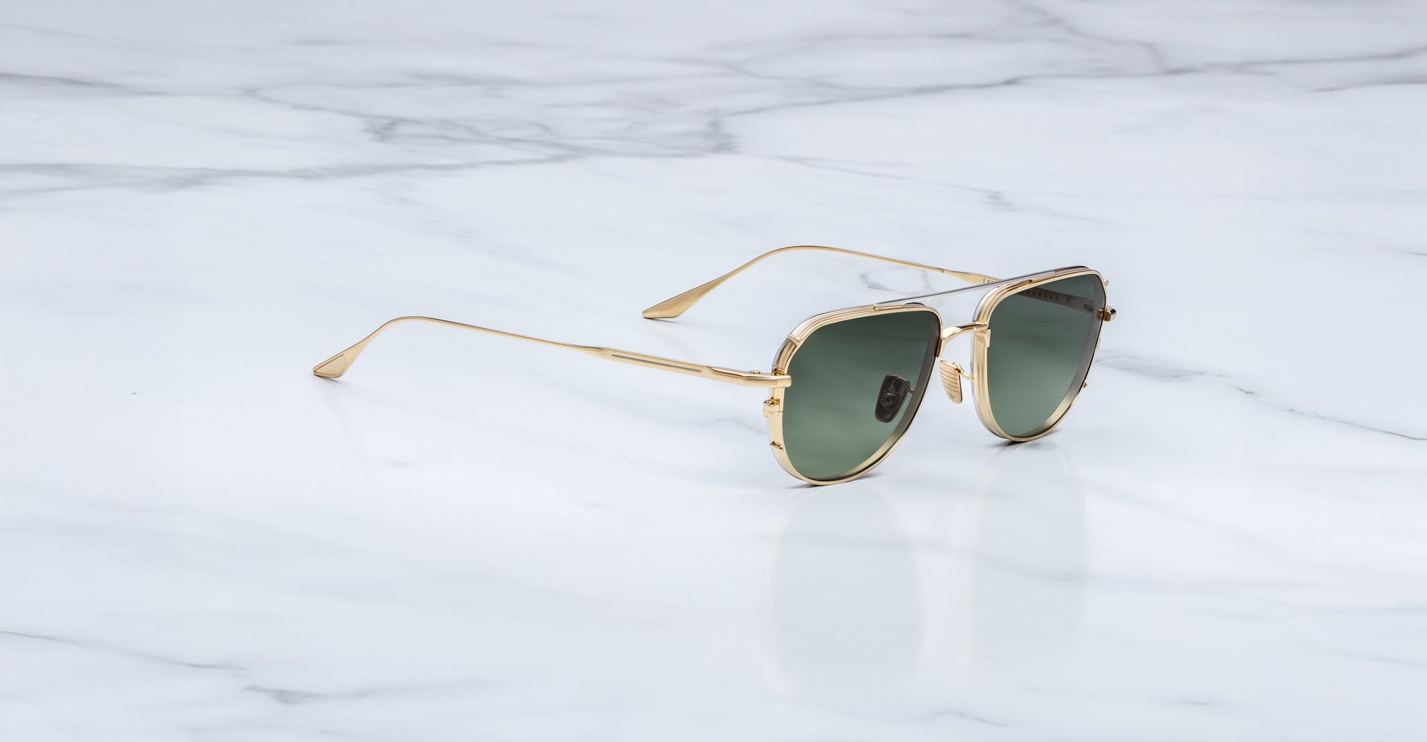 Jacques Marie Mage Cendrars aviator sunglasses with green lenses, top view.