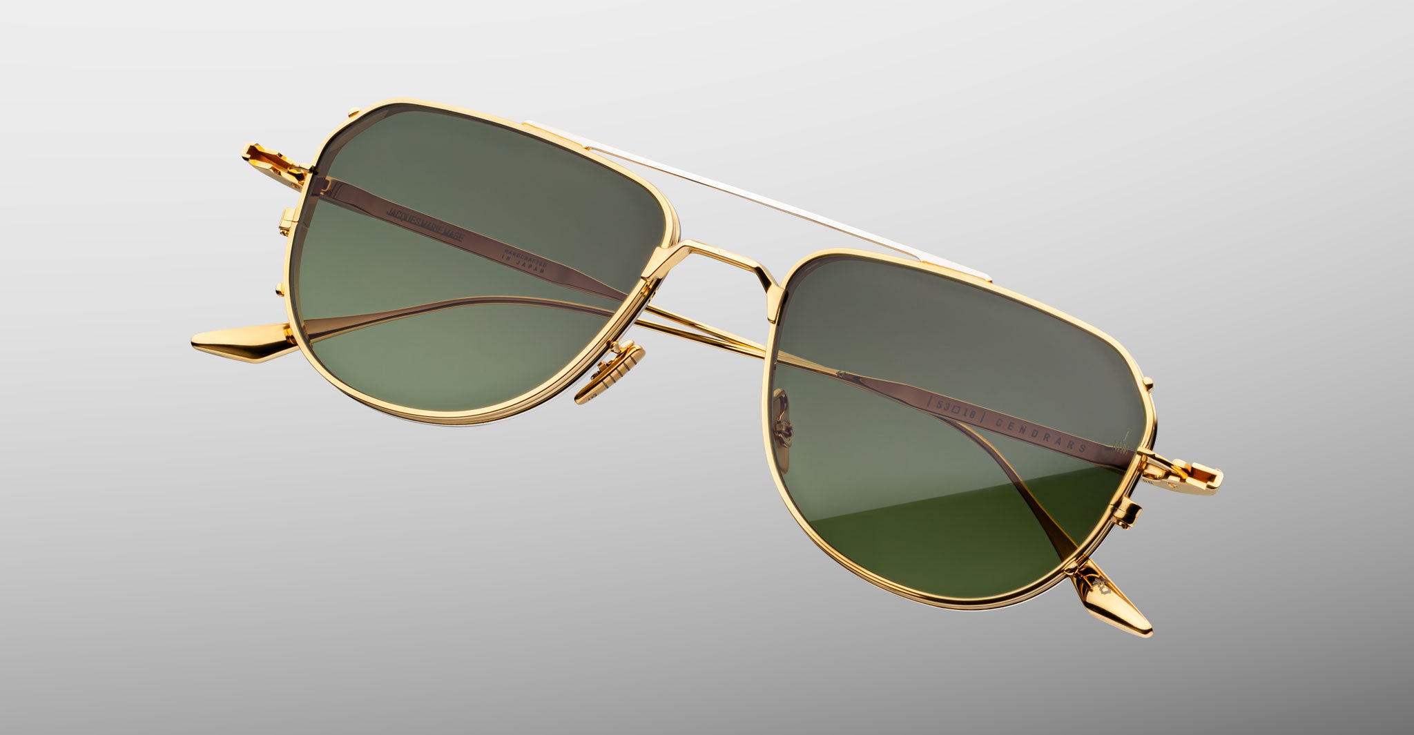 Jacques Marie Mage Cendrars gold aviator sunglasses with green lenses, front view.