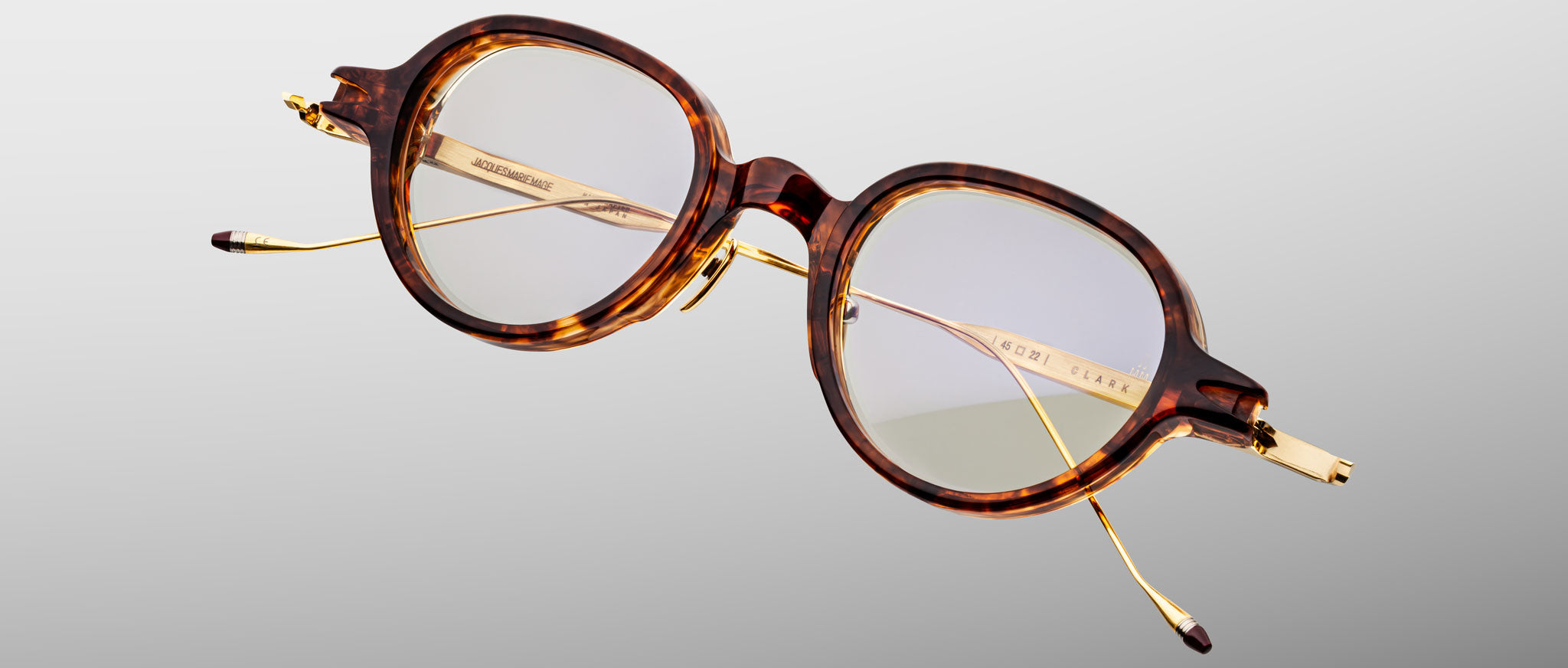 Jacques Marie Mage The Clark round tortoiseshell eyeglasses with gold temples and clear lenses, front angle.