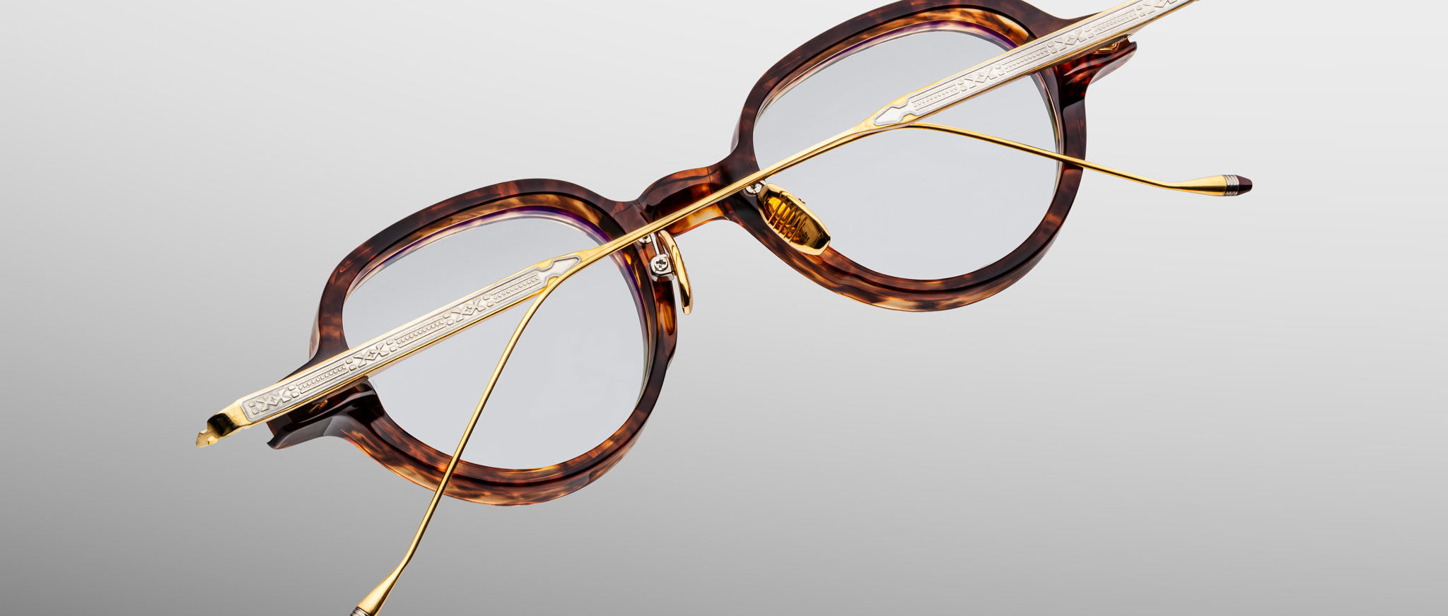 Jacques Marie Mage The Clark eyeglasses with gold temples shown upside down; top-down view highlights frame and temple details.
