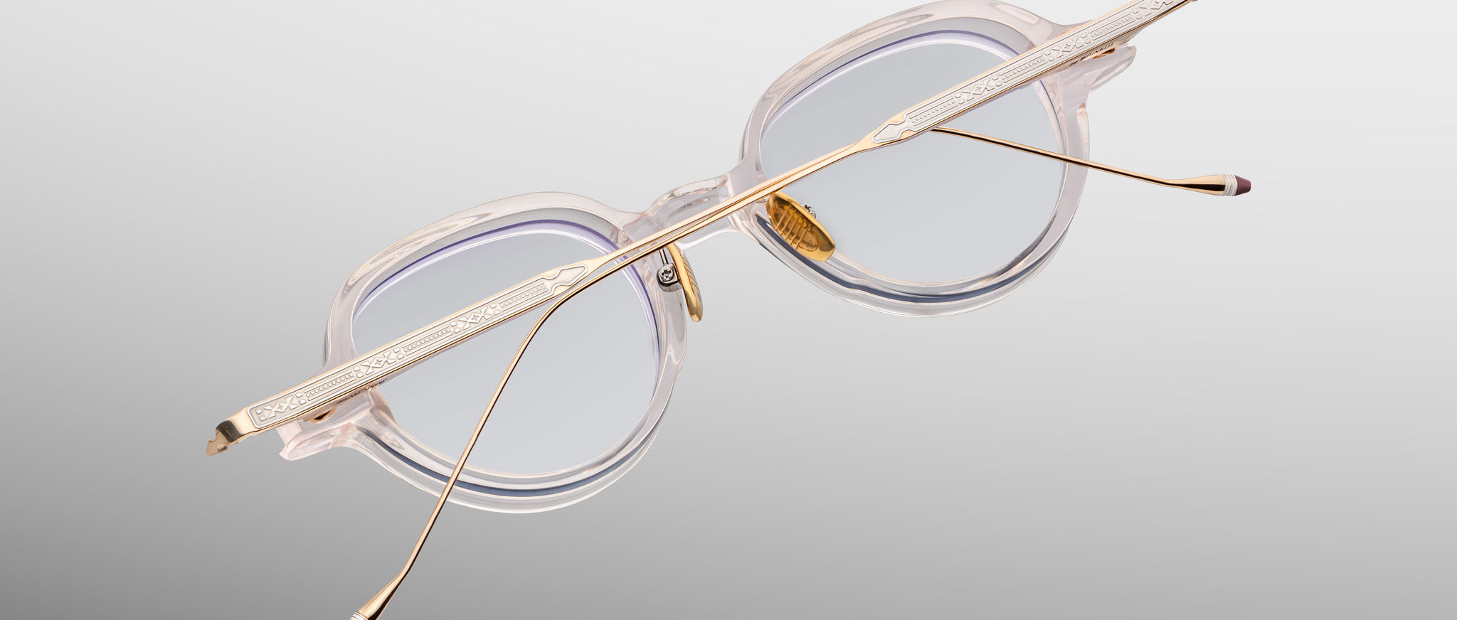 Jacques Marie Mage The Clark eyeglasses with clear frames and gold temples, shown from the front.
