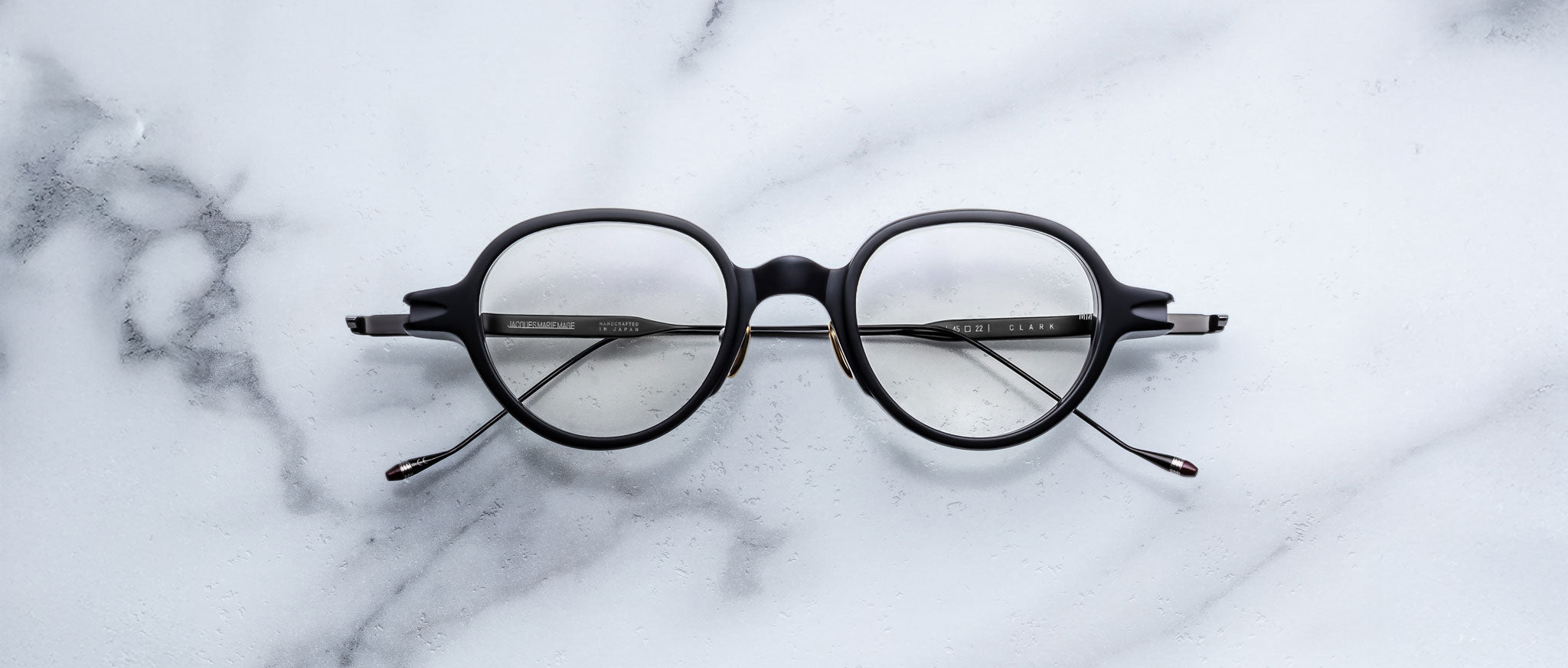 Jacques Marie Mage The Clark eyeglasses, front view, displayed on a flat surface.