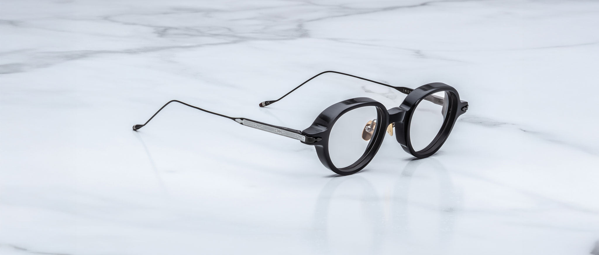 Jacques Marie Mage The Clark round black eyeglasses with thin metal arms, top view.