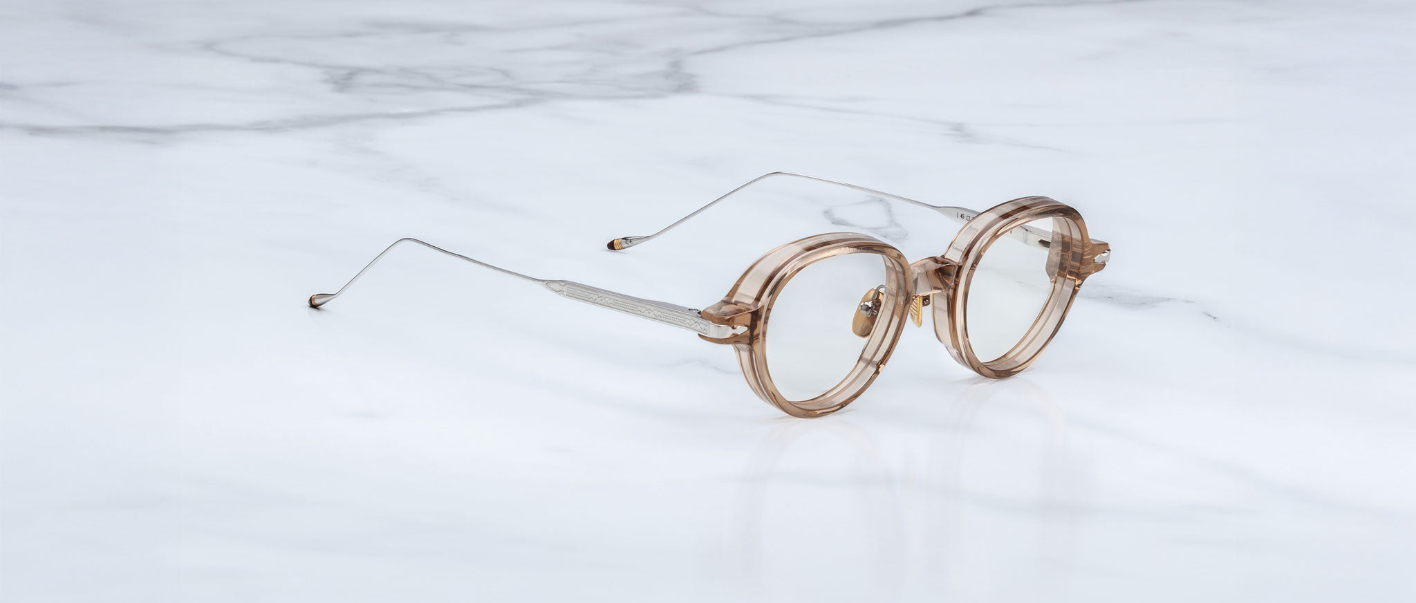 Jacques Marie Mage The Clark eyeglasses with thin metal arms, side view, displayed on a white surface.