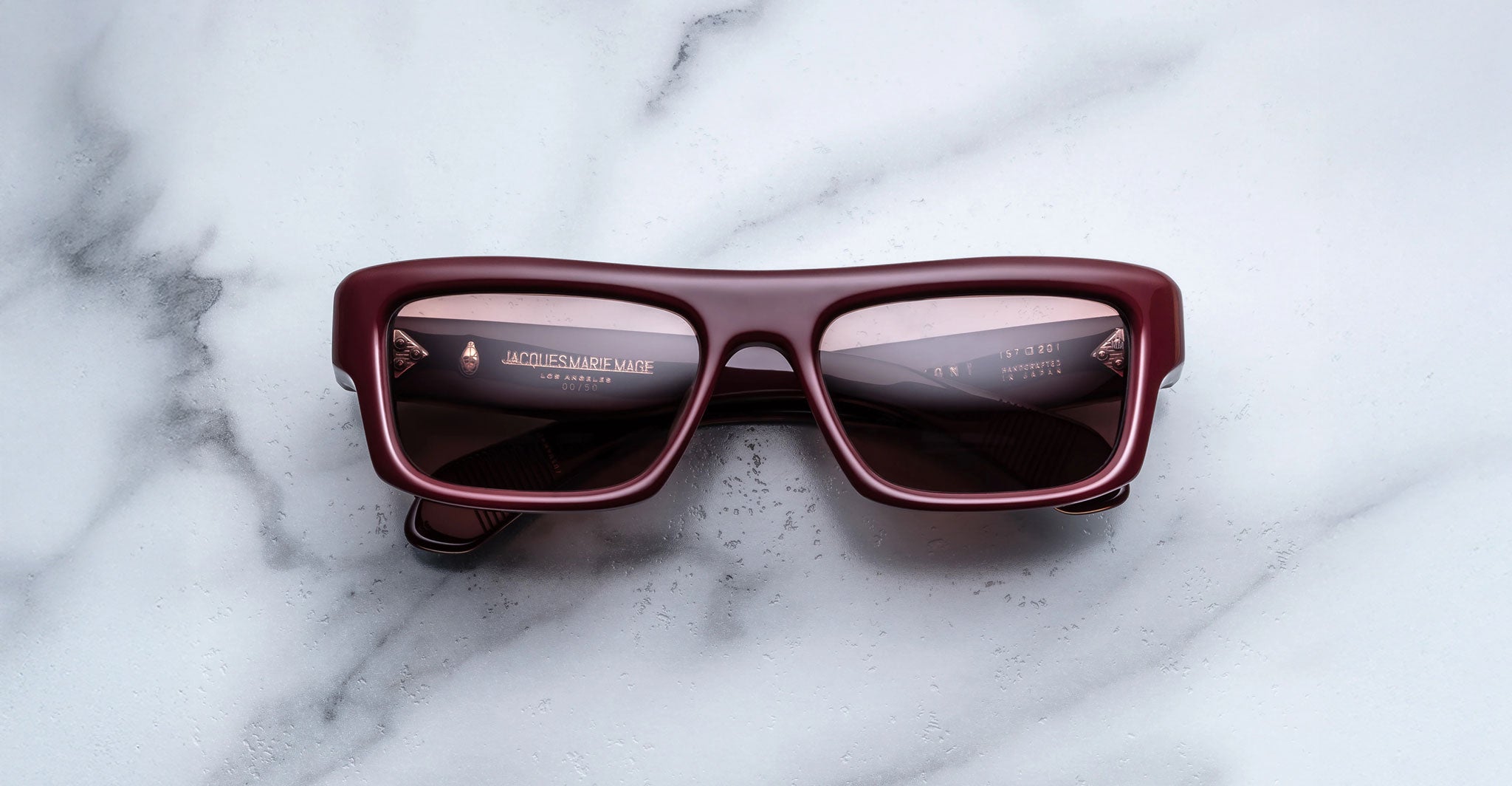 Jacques Marie Mage Cleavon 57 rectangular burgundy sunglasses with dark UV lenses, viewed from above.