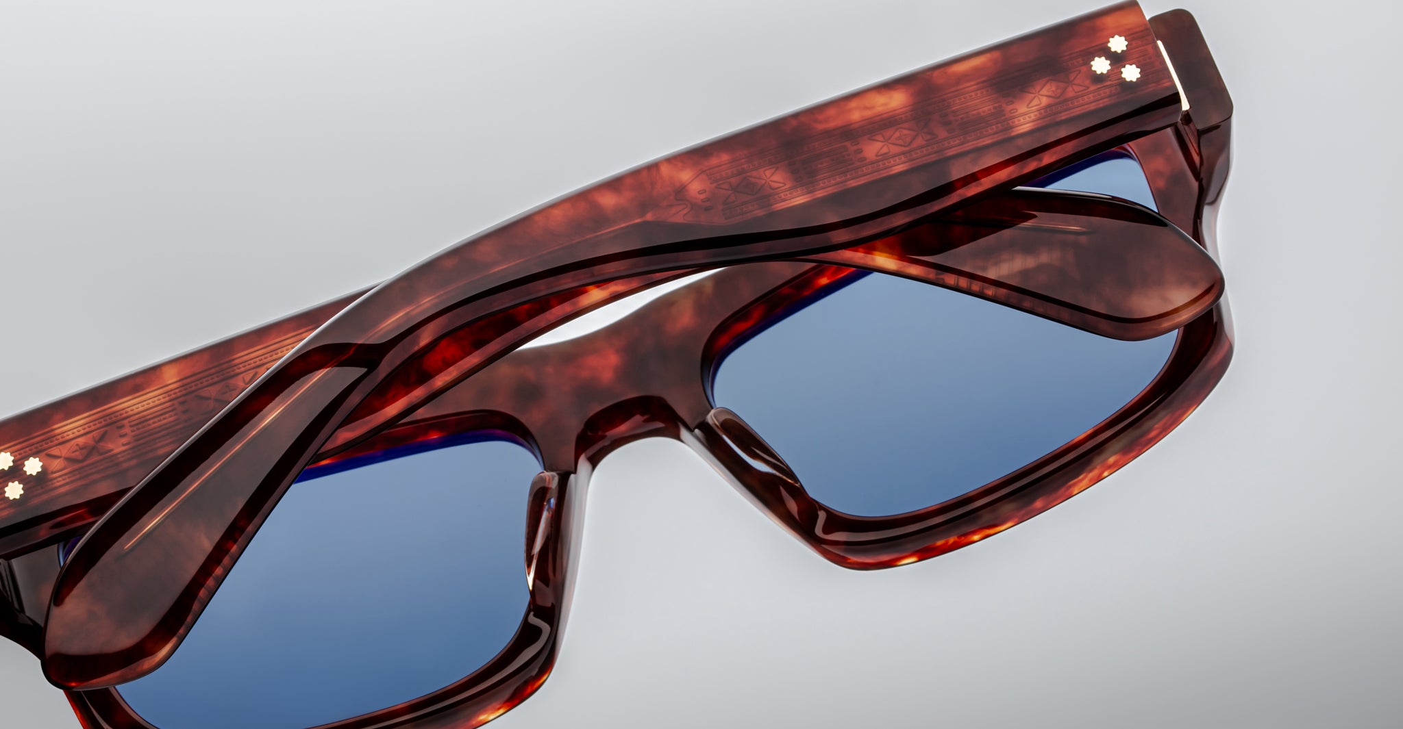Close-up of Jacques Marie Mage Cleavon 57 sunglasses, tortoiseshell frame and blue lenses, viewed from the front.
