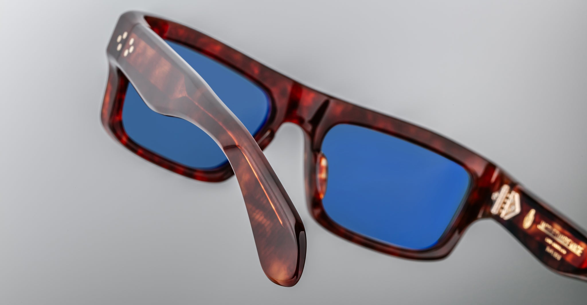 Jacques Marie Mage Cleavon 57 tortoiseshell eyeglasses with blue lenses, shown at an angle.