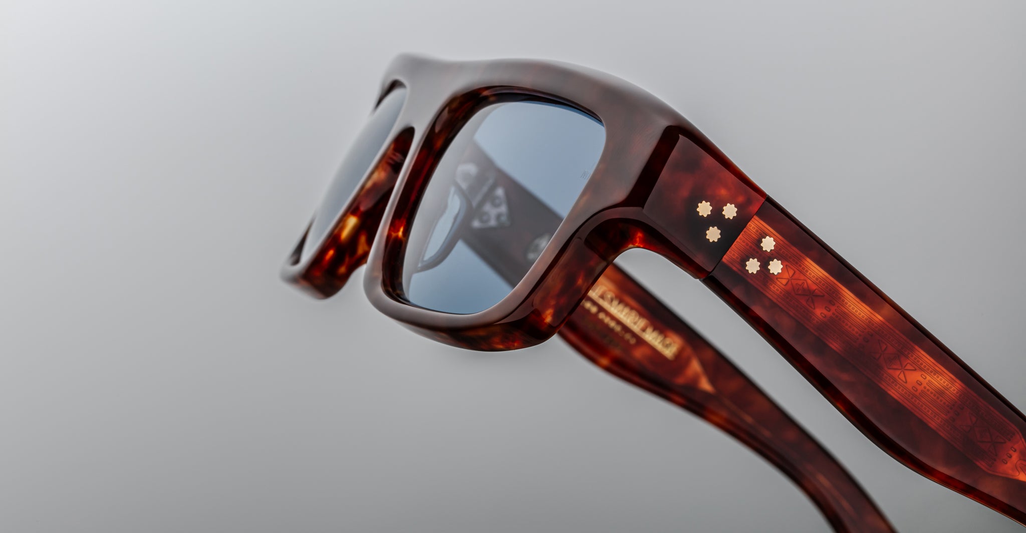 Close-up of Jacques Marie Mage Cleavon 57 sunglasses, tortoiseshell frame with gold accents, front angle.