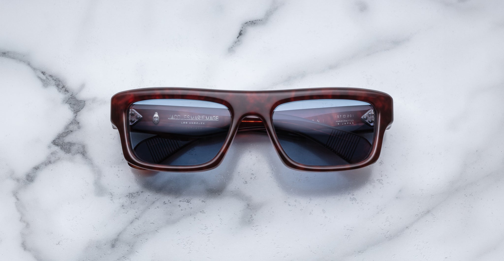 Jacques Marie Mage Cleavon 57 dark tortoiseshell sunglasses with bold frames, viewed from above.
