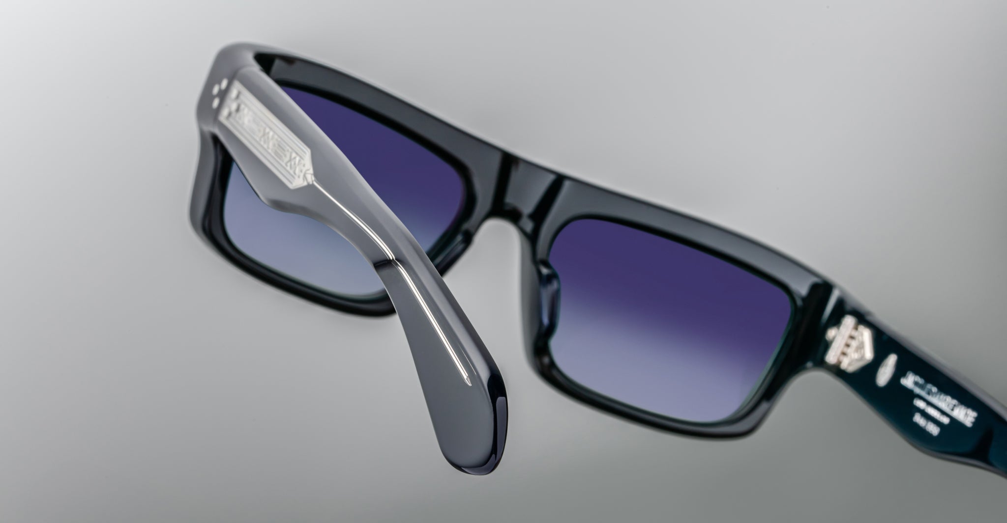 Jacques Marie Mage Cleavon 57 black sunglasses with blue gradient lenses and metallic logos, front view.