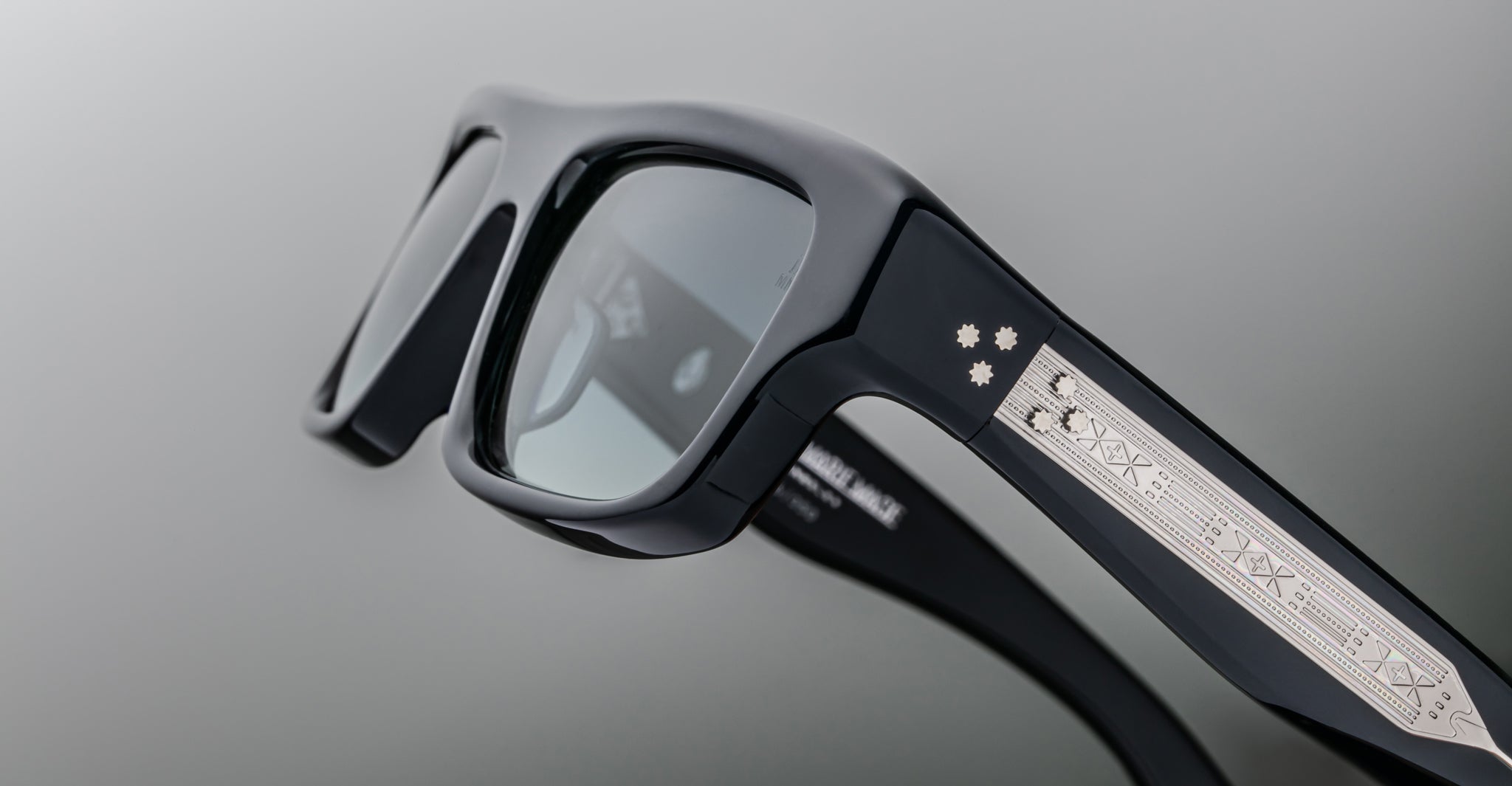 Jacques Marie Mage Cleavon 57 sunglasses, front view, black frame with silver accents and engraved symbols on temples.