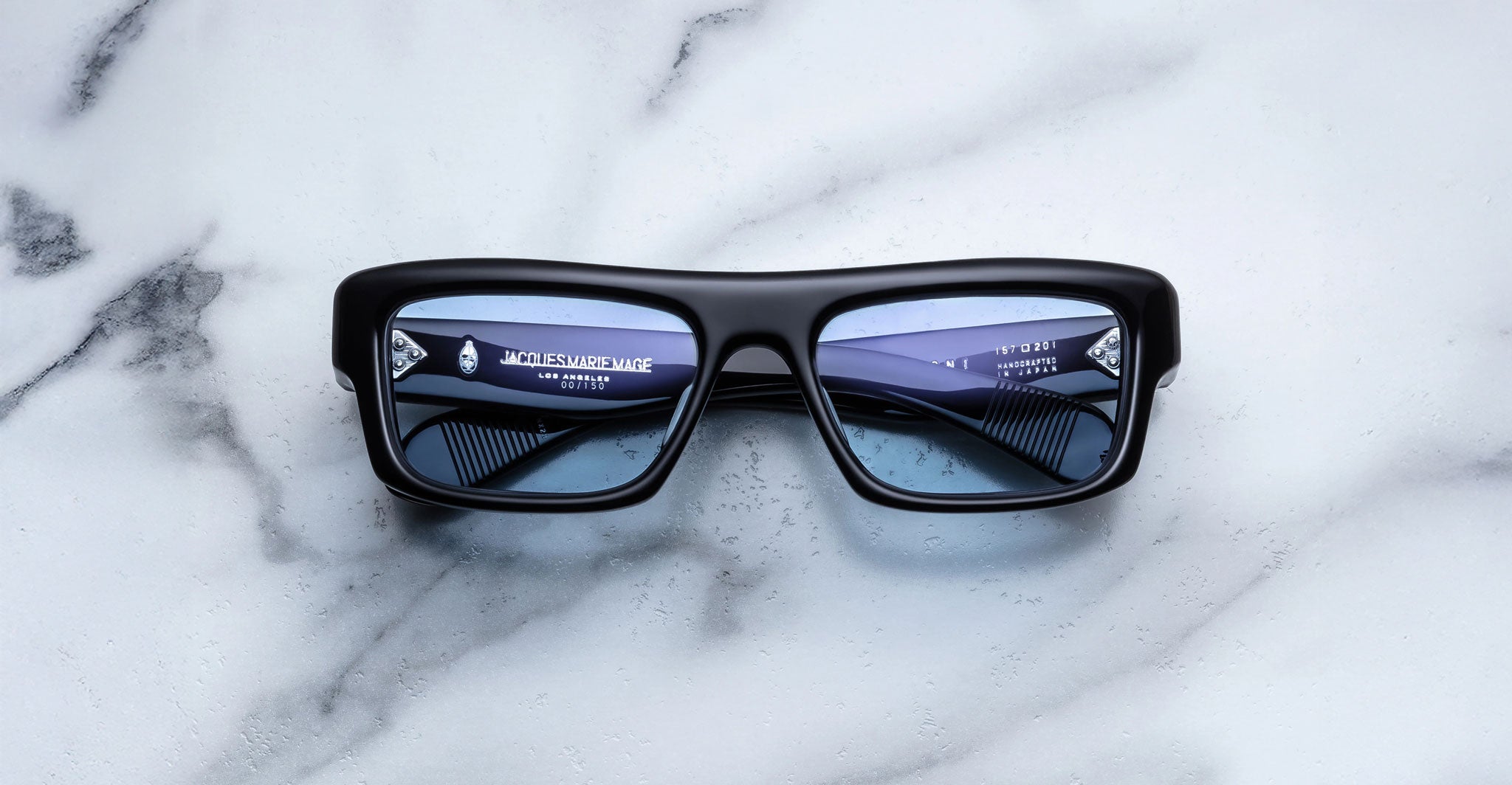 Jacques Marie Mage Cleavon 57 black rectangular sunglasses with blue polarized lenses, top view.