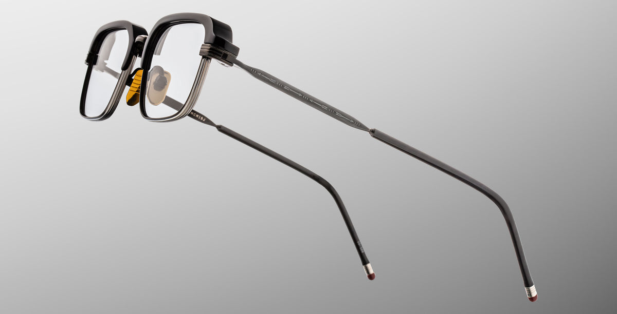 Jacques Marie Mage Comanche in Corbeau black rectangular eyeglasses with metal arms and nose pads, profile view.