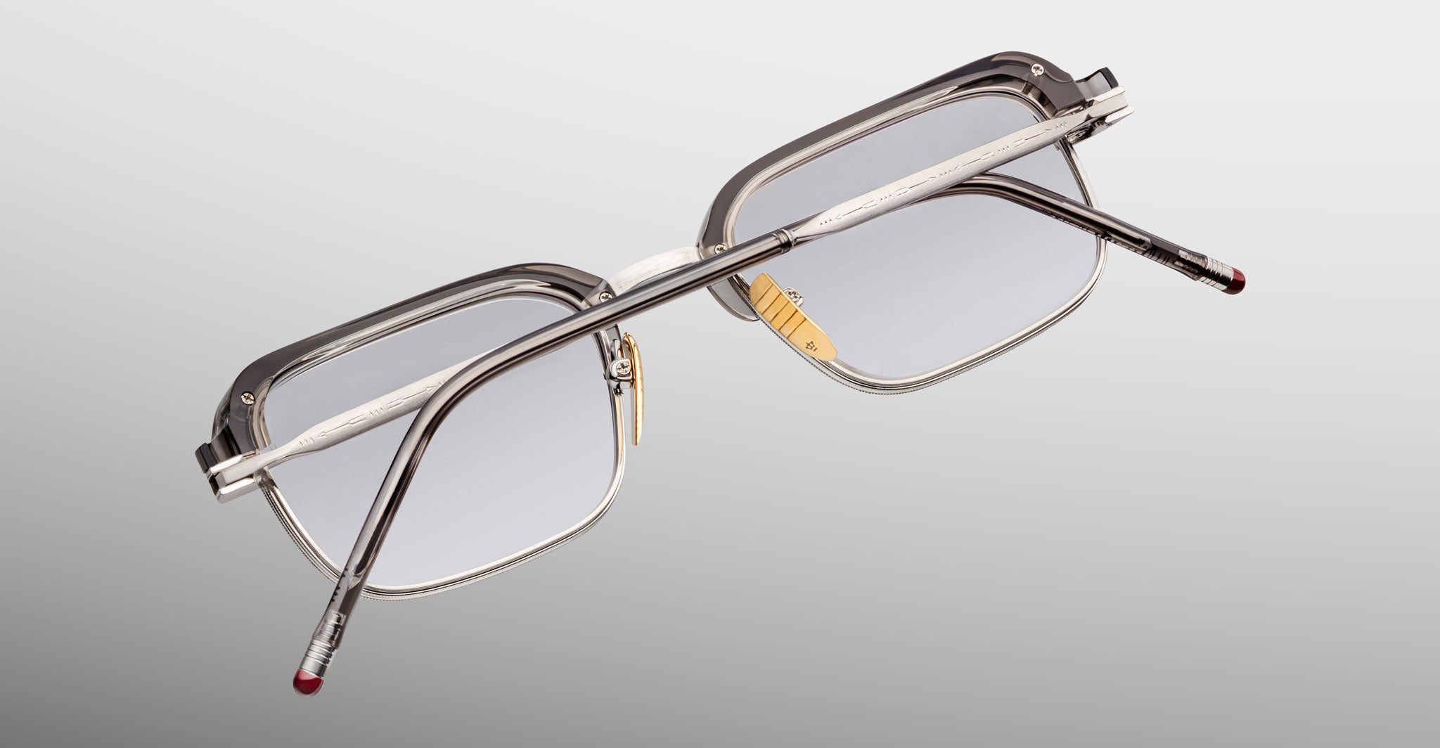 Jacques Marie Mage Comanche in Tempest rectangular eyeglasses with clear frames and silver arms, viewed from the back.
