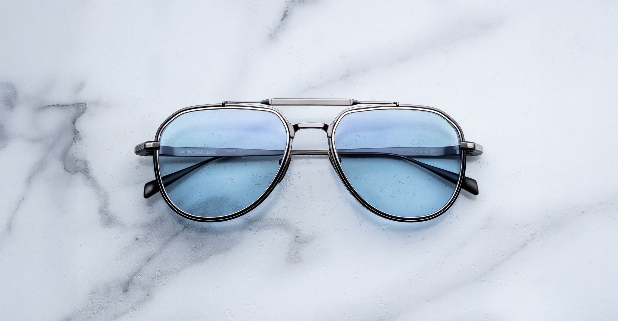 Front-facing view of Jacques Marie Mage Commander in Antique Silver, featuring an antique silver-tone double-bridge titanium frame with aviator lenses in a cool blue tint and finely engraved rims.