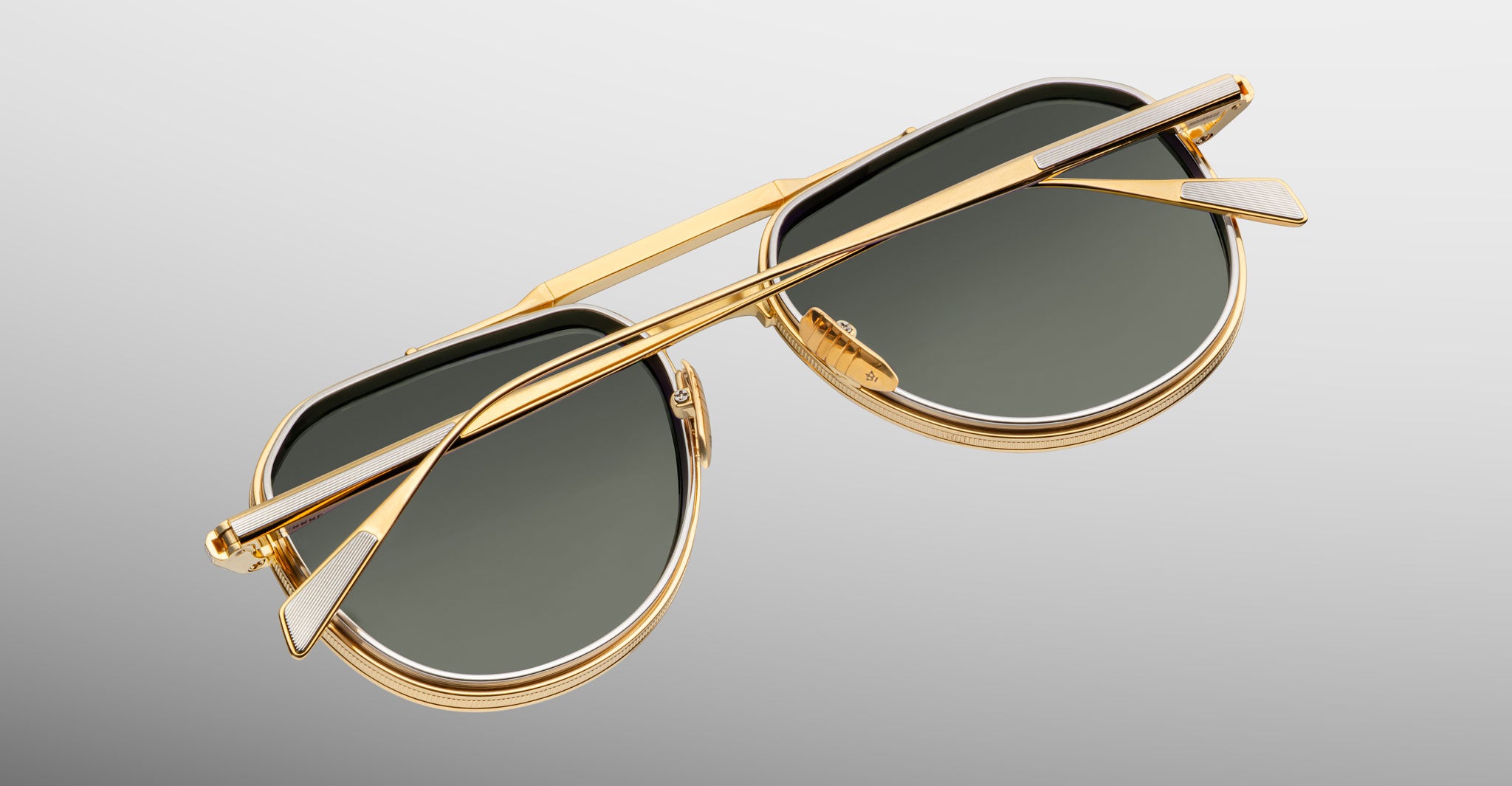 Top-down view of Jacques Marie Mage Commander in Musket, revealing the gold-tone titanium frame, double bridge construction, engraved rims, and slender temples with signature inlaid tips.