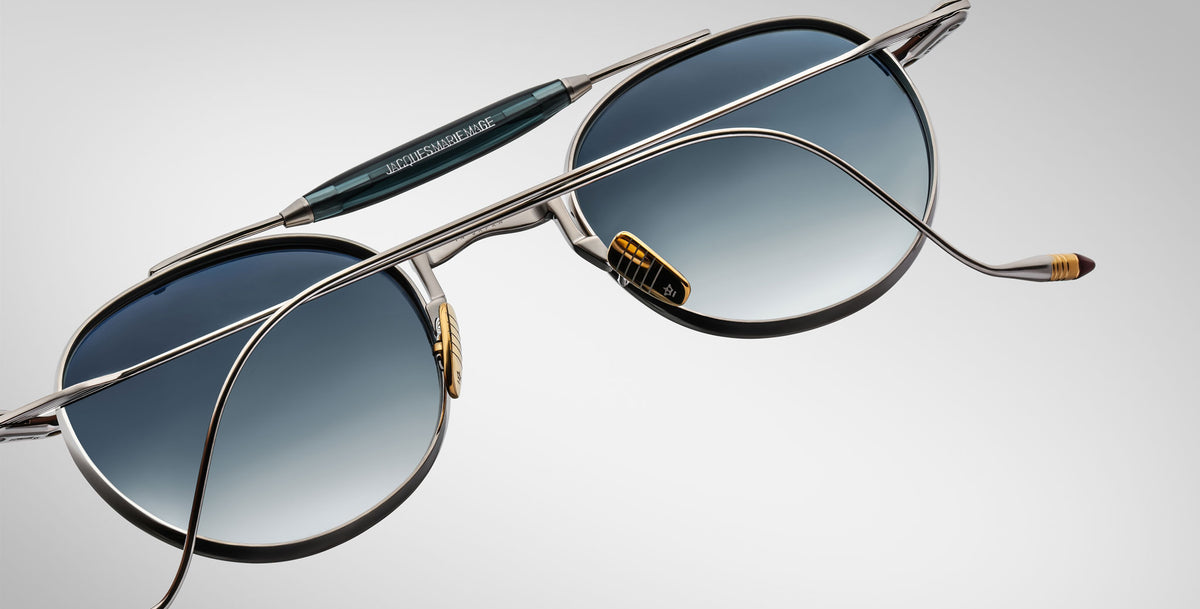 Detailed back view of the Jacques Marie Mage Dasan titanium sunglass in silver with blue gradient lenses on a white background