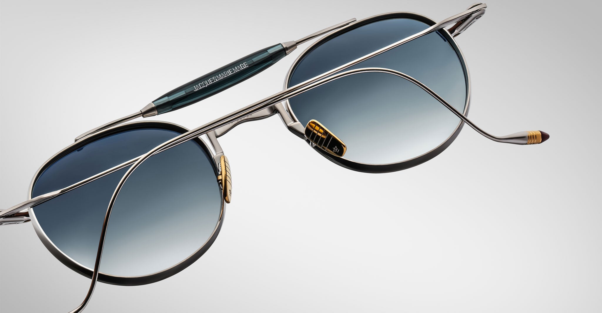 Detailed back view of the Jacques Marie Mage Dasan titanium sunglass in silver with blue gradient lenses on a white background