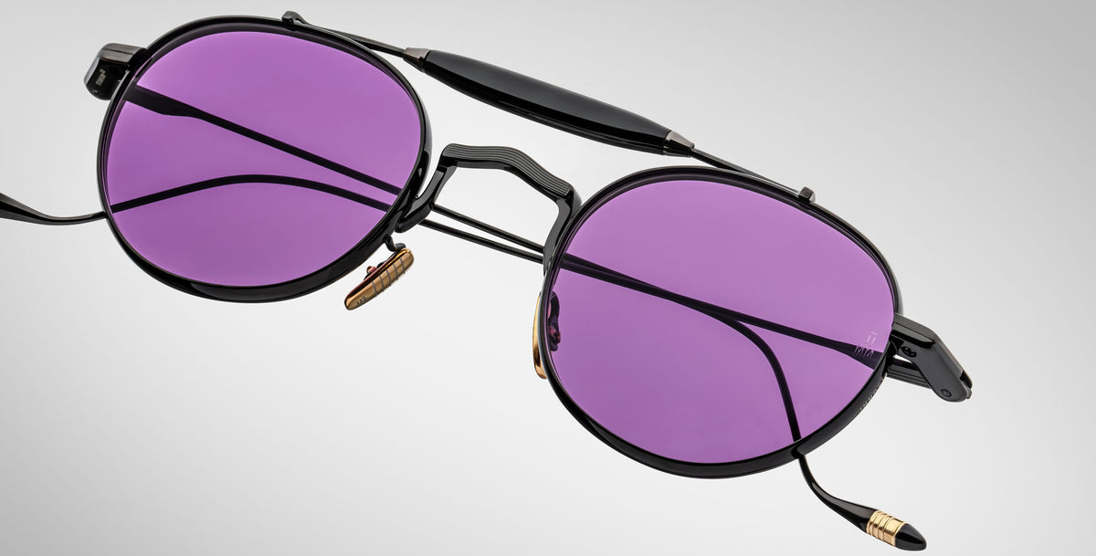 Detailed front view of the Jacques Marie Mage Dasan titanium sunglass in black color with purple lenses on a white background