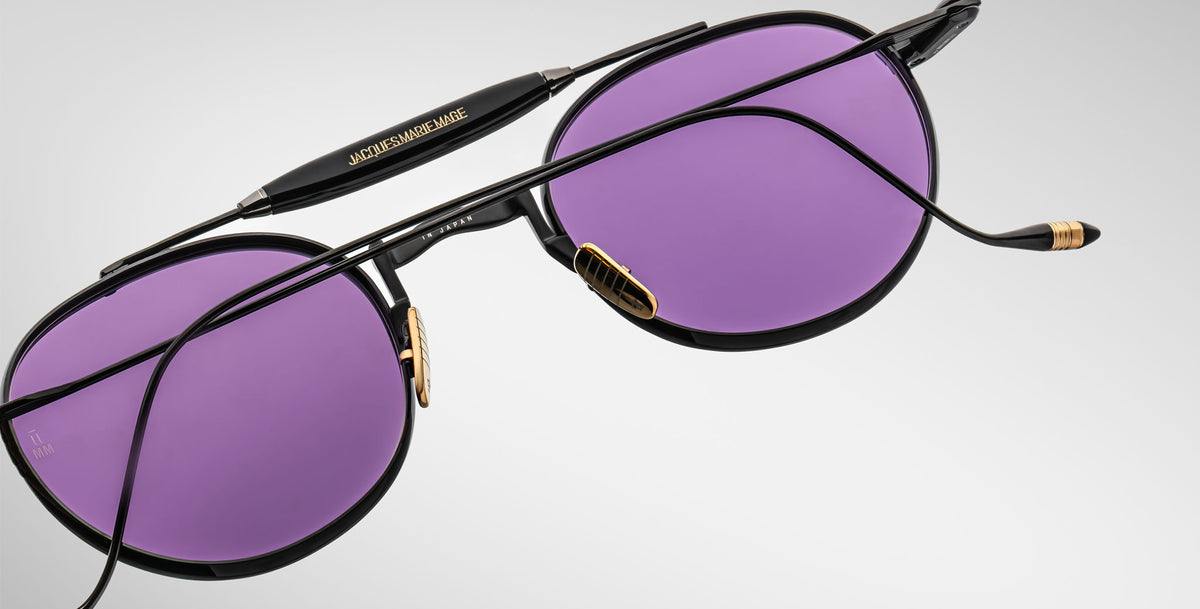 Detailed back view of the Jacques Marie Mage Dasan titanium sunglass in black color with purple lenses on a white background