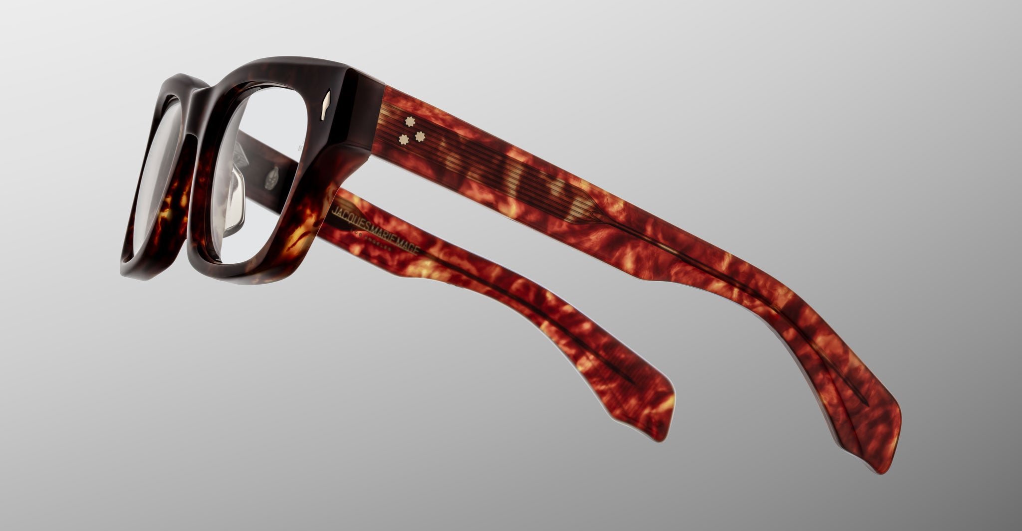 The Jacques Marie Mage Dealan 53 features thick rectangular frames and arms in a tortoiseshell pattern, displayed from a side angle against a plain light gray background.