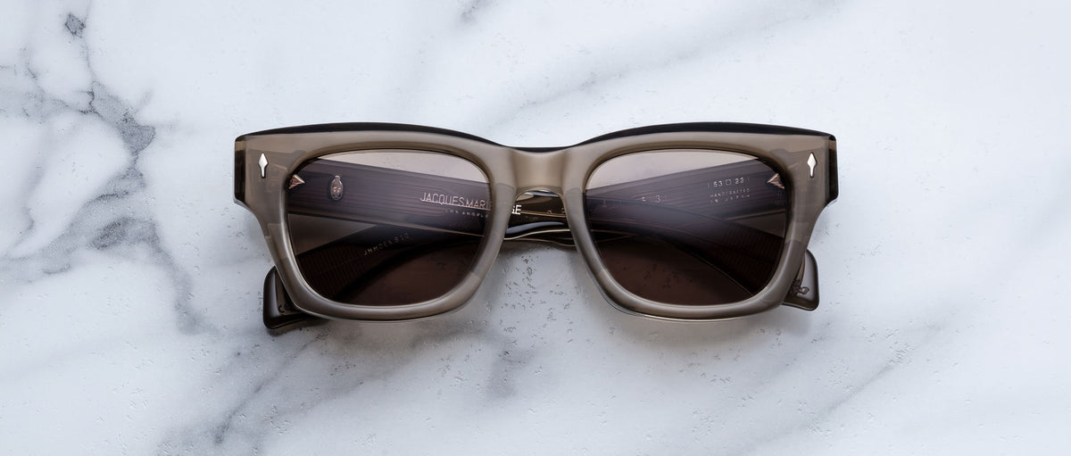 Jacques Marie Mage Dealan 53 sunglasses, black and gray with dark lenses, shown from above.