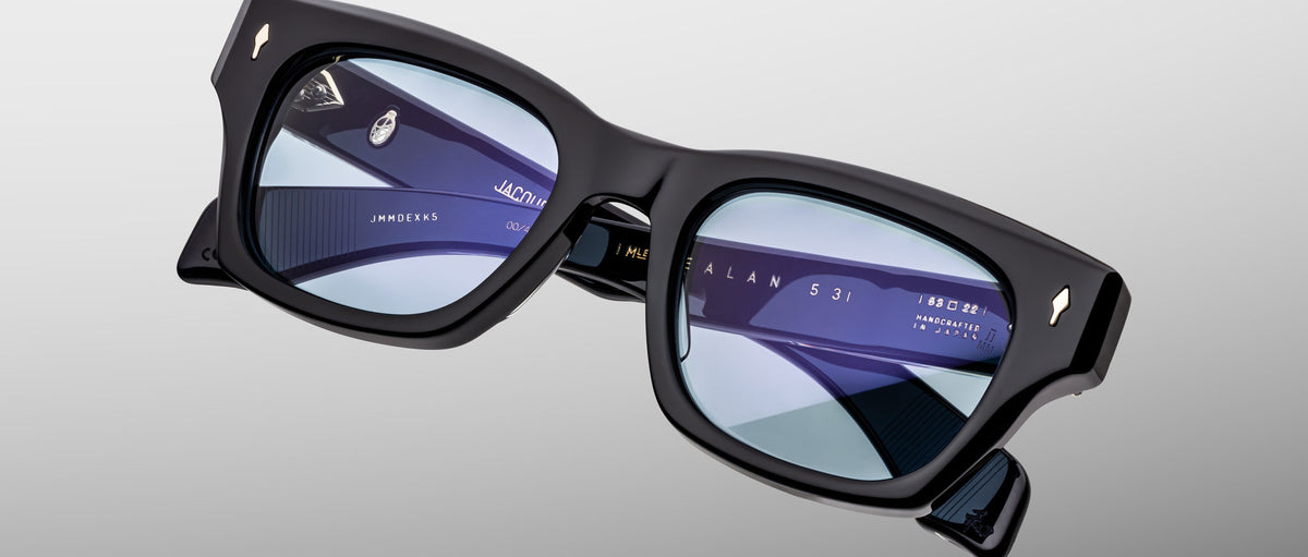 Jacques Marie Mage Dealan 53 eyeglasses, black rectangular frame with blue-tinted lenses, front view.