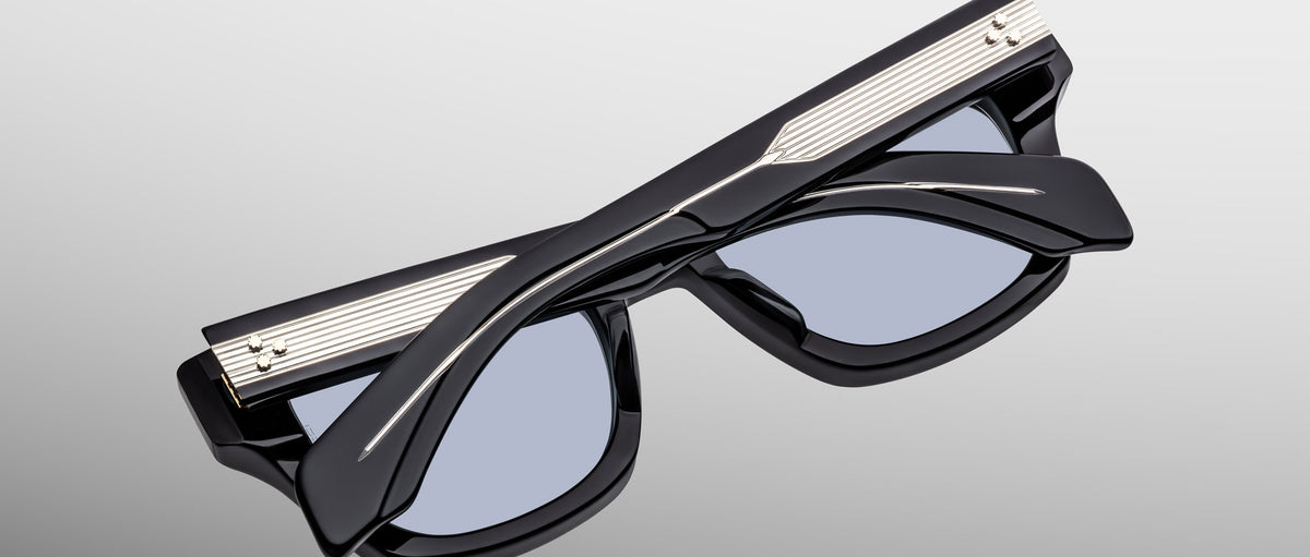 Jacques Marie Mage Dealan 53 black polarized sunglasses with silver accents, folded, top view.