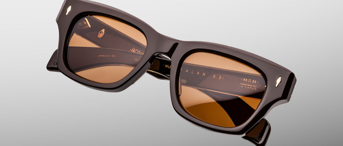 Jacques Marie Mage Dealan 53 sunglasses, front view, featuring bold brown frames and amber lenses.