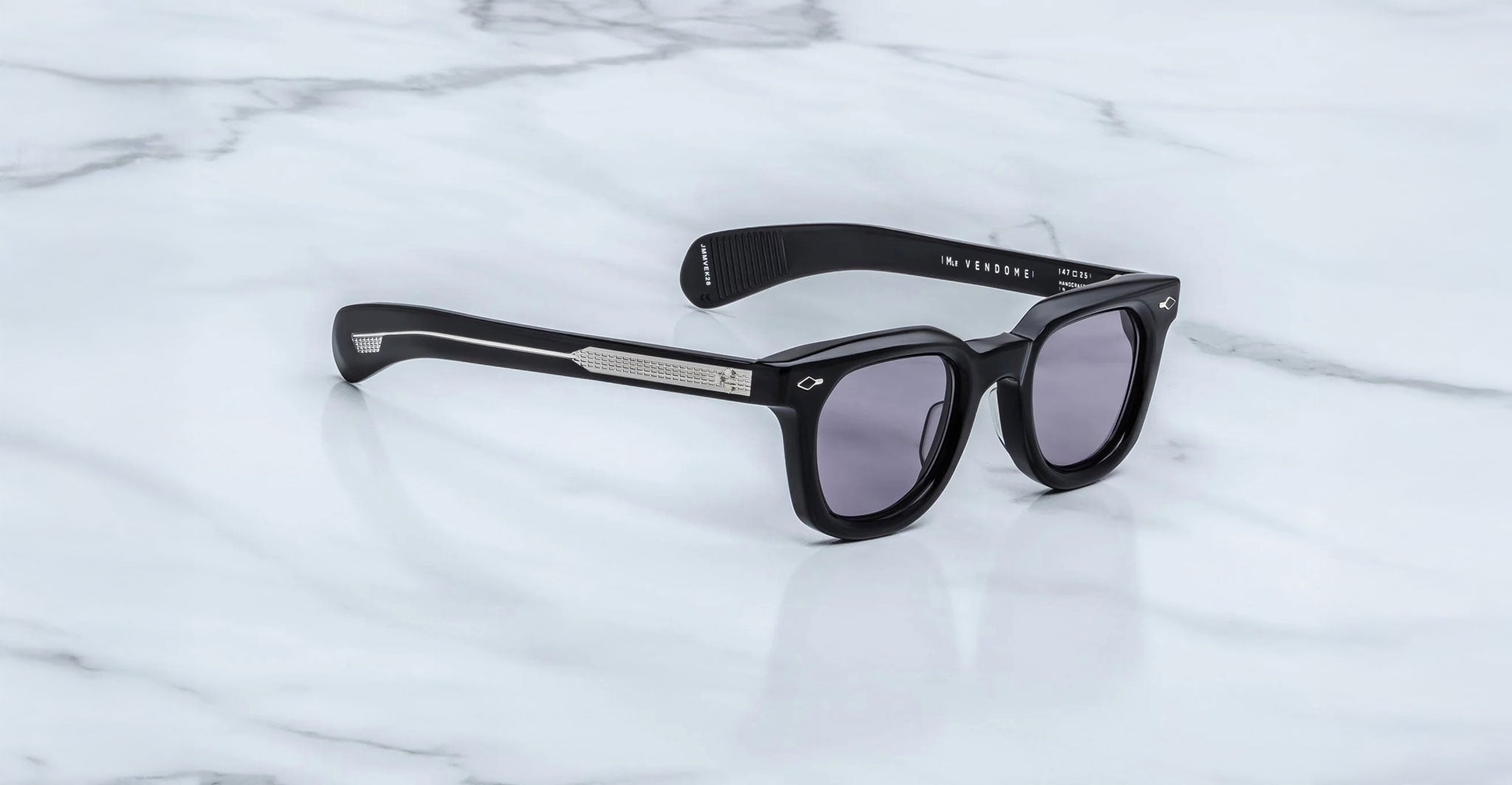Jacques Marie Mage Dealan black rectangular sunglasses with dark lenses and silver arms, front angle view.