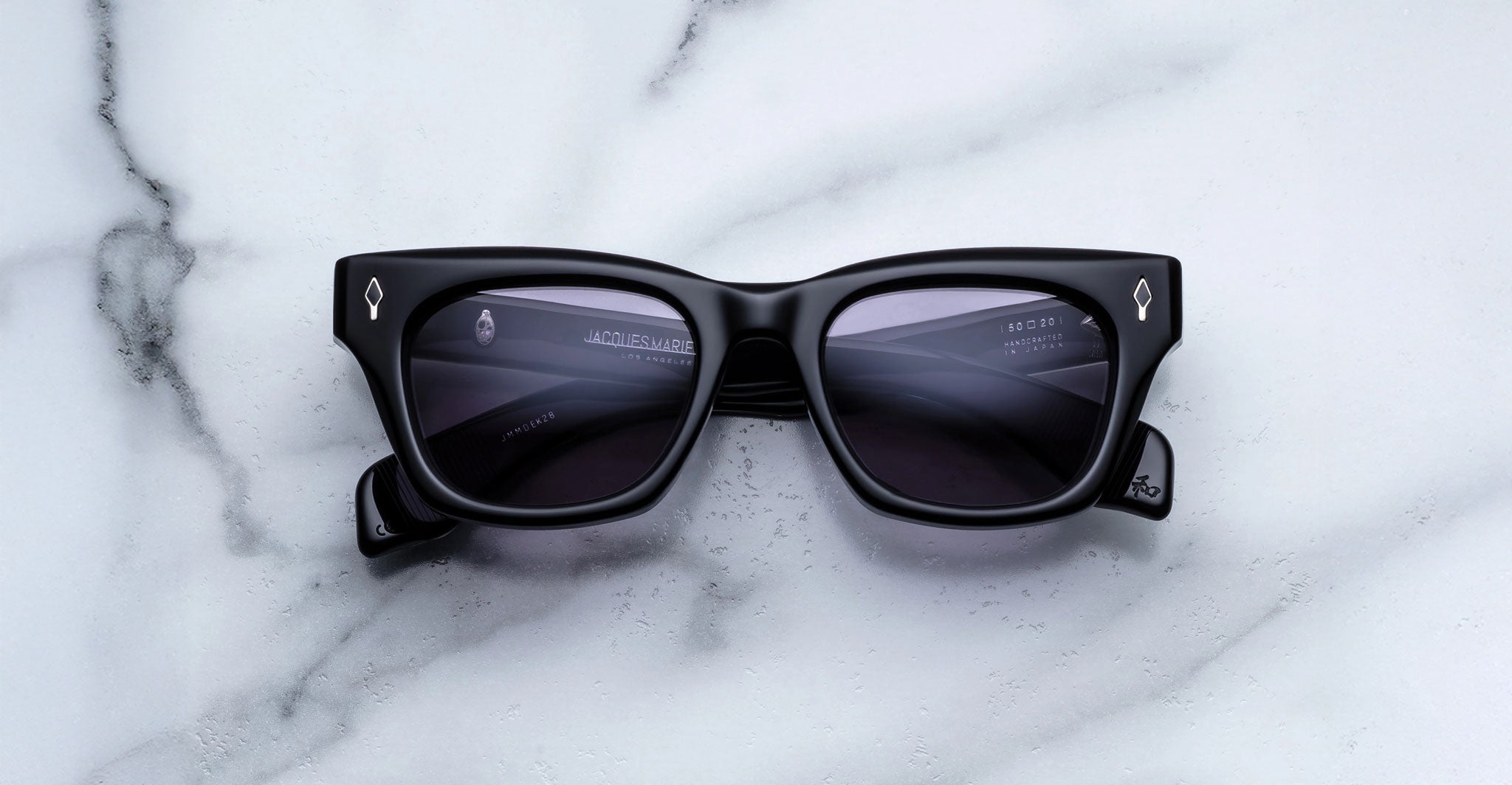 Jacques Marie Mage Dealan black rectangular sunglasses with dark lenses, shown from above.