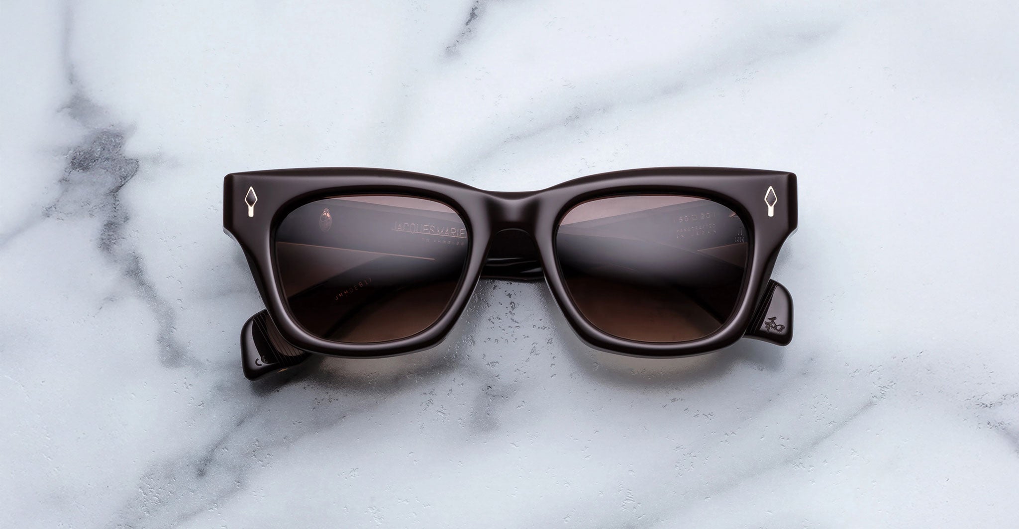 Jacques Marie Mage Dealan black rectangular sunglasses with dark lenses, top view.