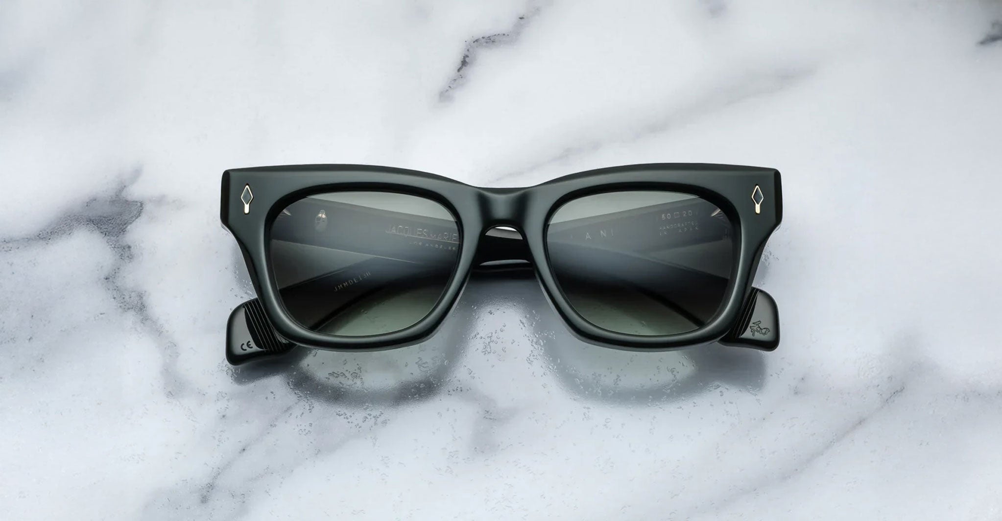 Jacques Marie Mage Dealan black rectangular sunglasses with dark lenses, top view.