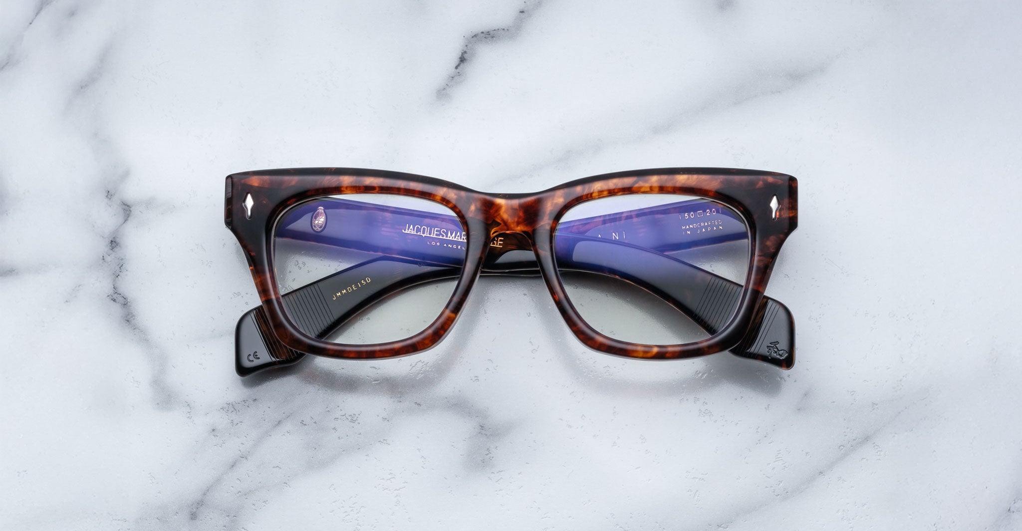 Jacques Marie Mage Dealan rectangular eyeglasses with clear lenses, viewed from above.