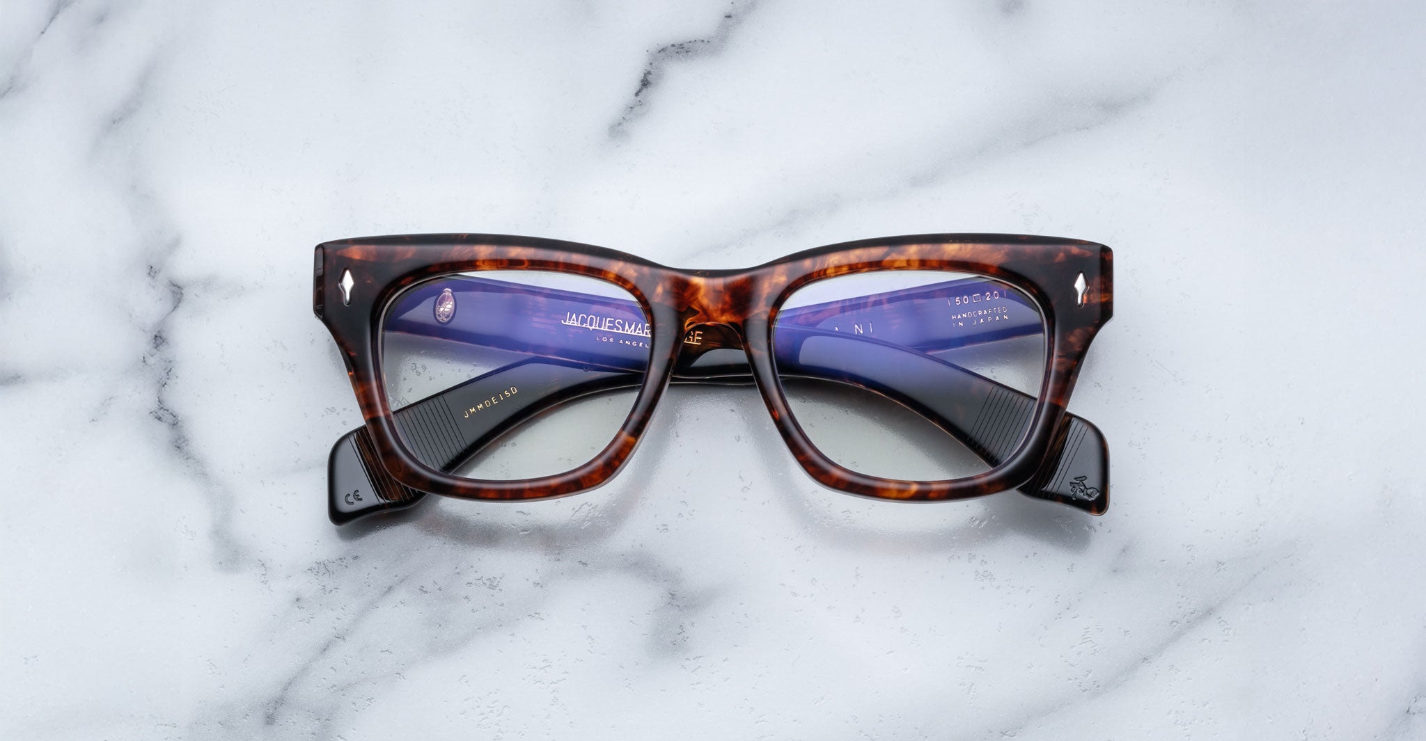 Jacques Marie Mage Dealan rectangular eyeglasses with clear lenses, viewed from above.