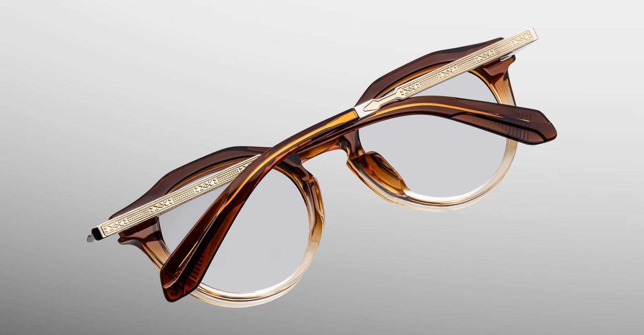 Jacques Marie Mage Desnos eyeglasses with brown and gold frames, decorative temples, shown from the front.