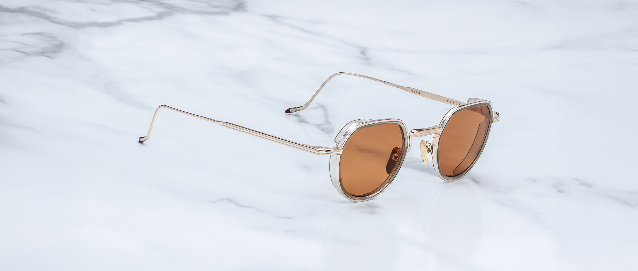 Jacques Marie Mage Dixon gold sunglasses with brown lenses, viewed from above, showing retro frame design.