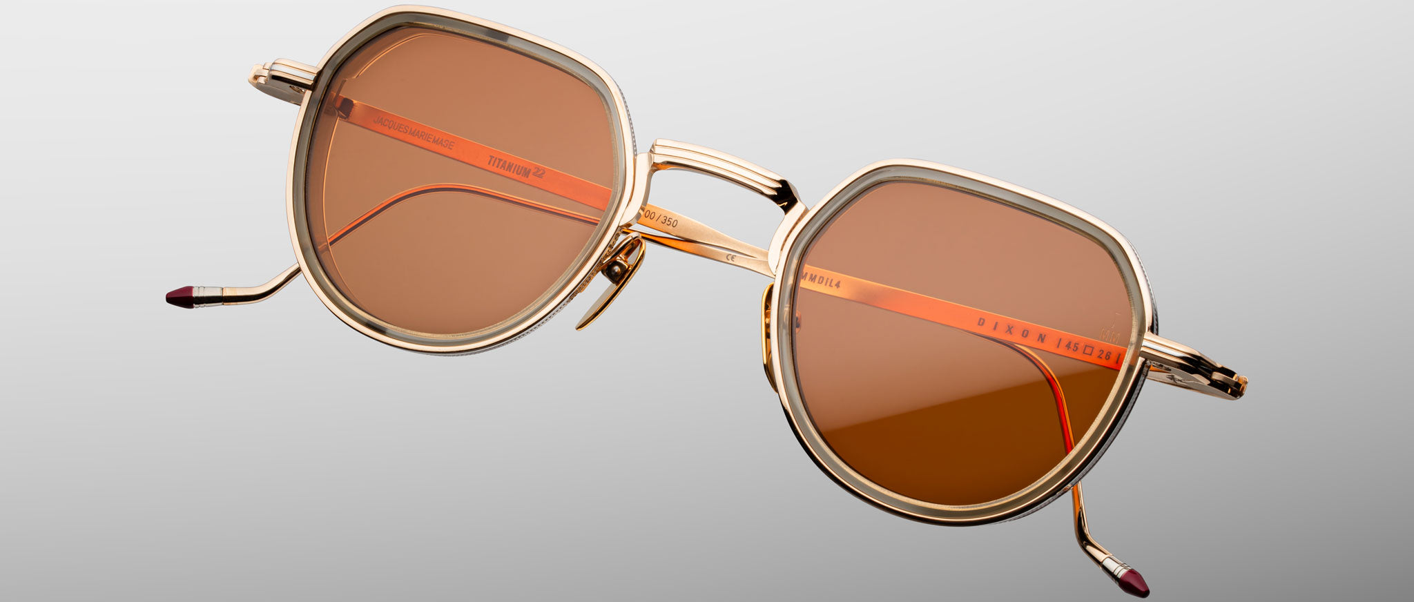 Jacques Marie Mage Dixon sunglasses, gold frame with brown lenses and orange accents, classic style, front angle.