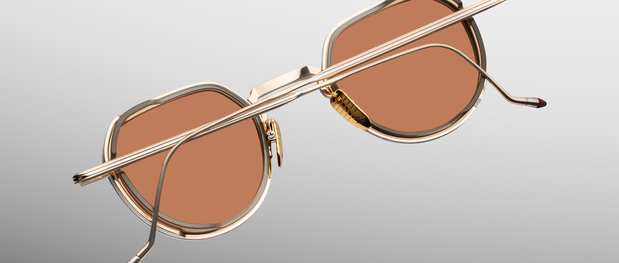 Jacques Marie Mage Dixon gold aviator sunglasses with brown lenses, shown from the back.