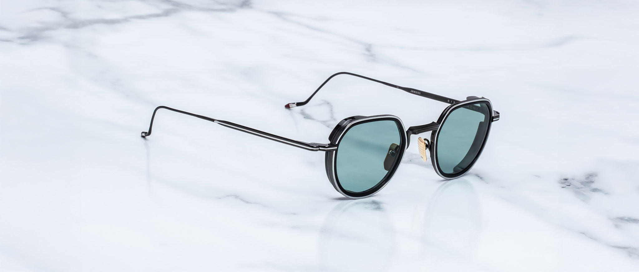 Jacques Marie Mage Dixon round black sunglasses with green lenses, front view.
