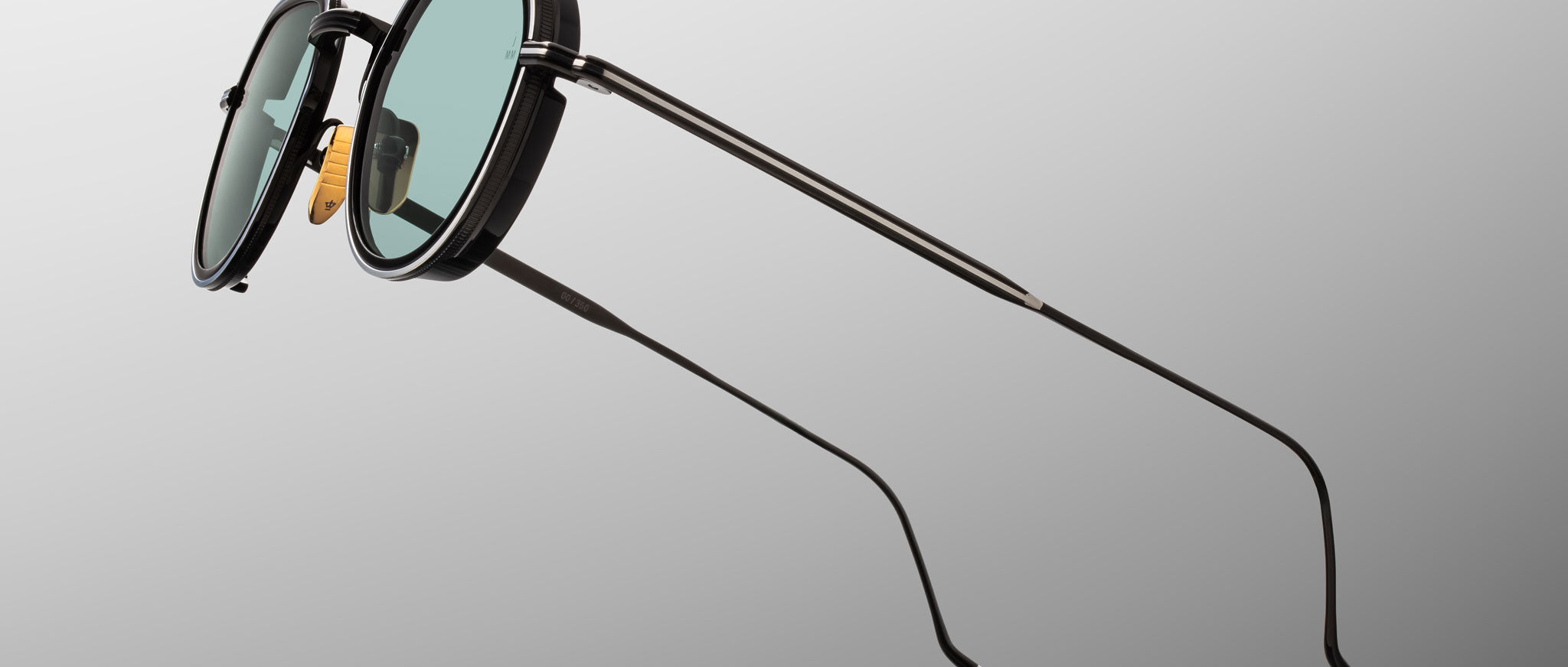 Jacques Marie Mage Dixon sunglasses, black metal rims, green lenses, thin temples, front angle view.