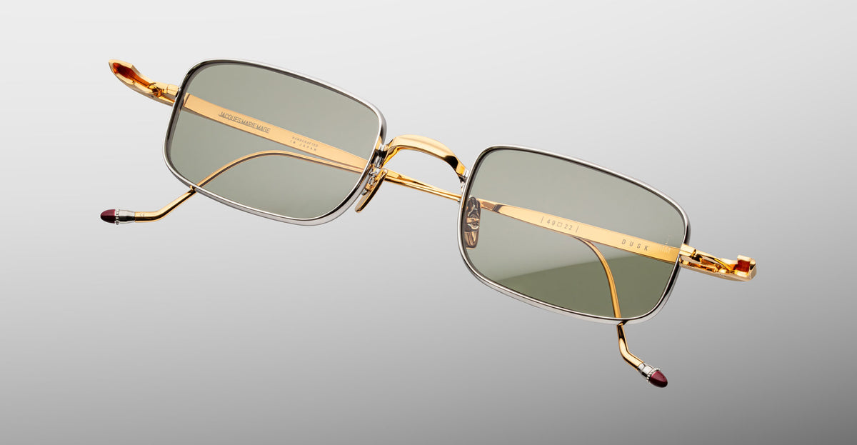 Jacques Marie Mage Dusk sunglasses with rectangular gold frames and green lenses, shown from the front.