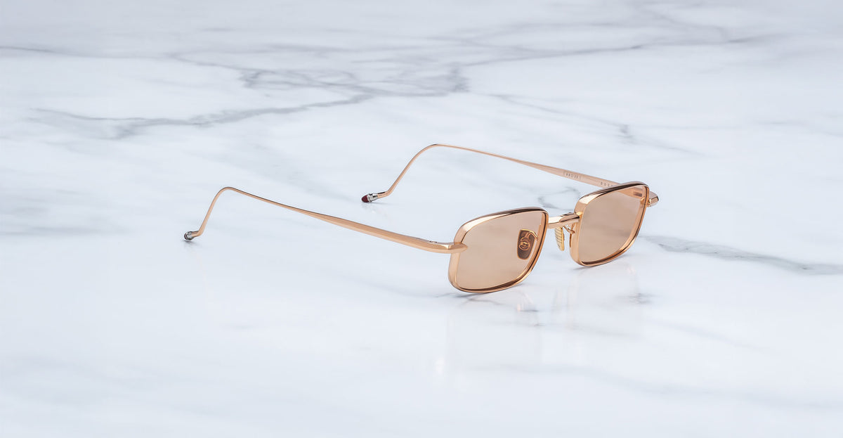 Jacques Marie Mage Dusk sunglasses with brown lenses shown from above; front view of frames and lenses visible.
