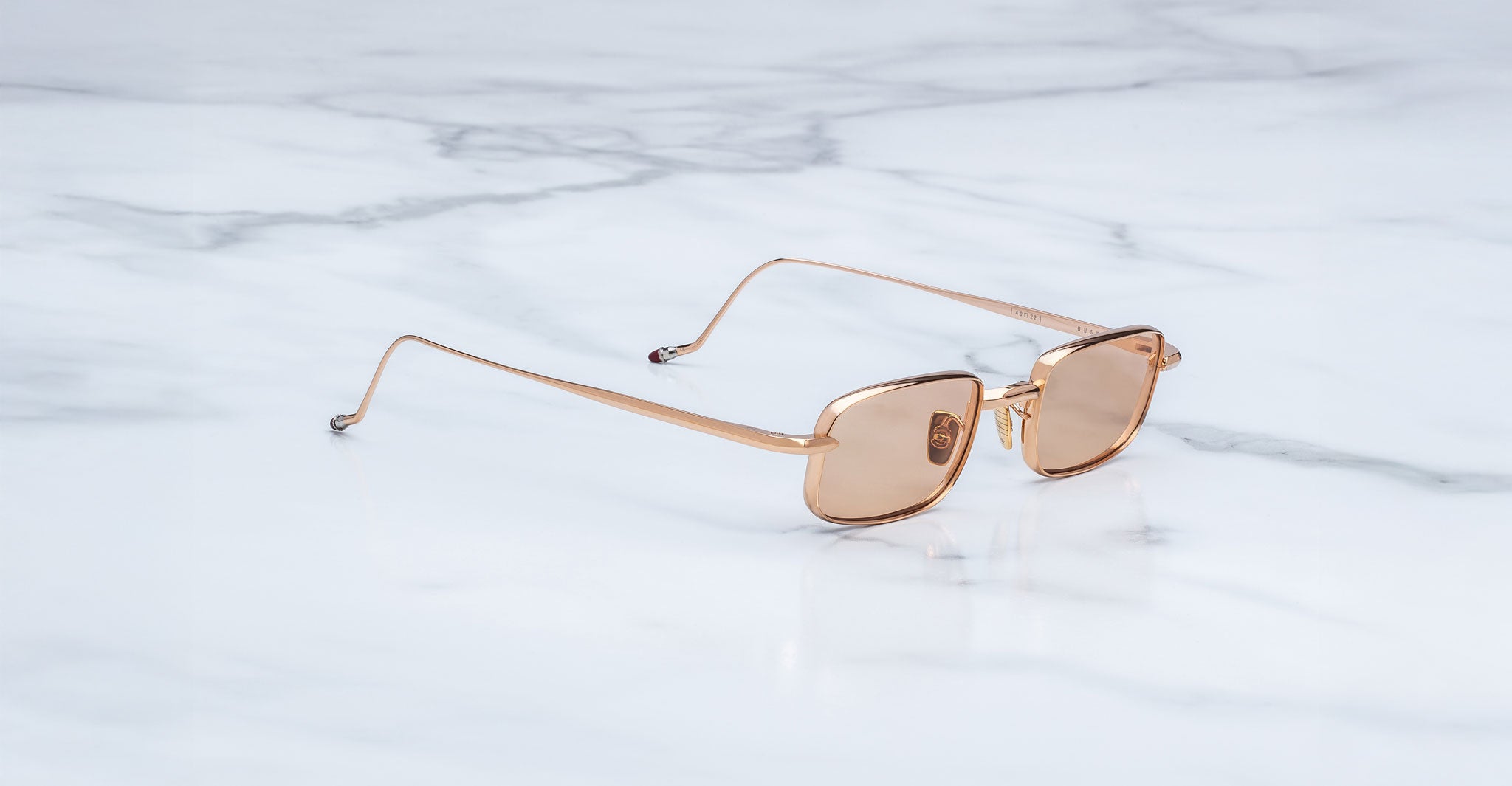 Jacques Marie Mage Dusk sunglasses with brown lenses shown from above; front view of frames and lenses visible.