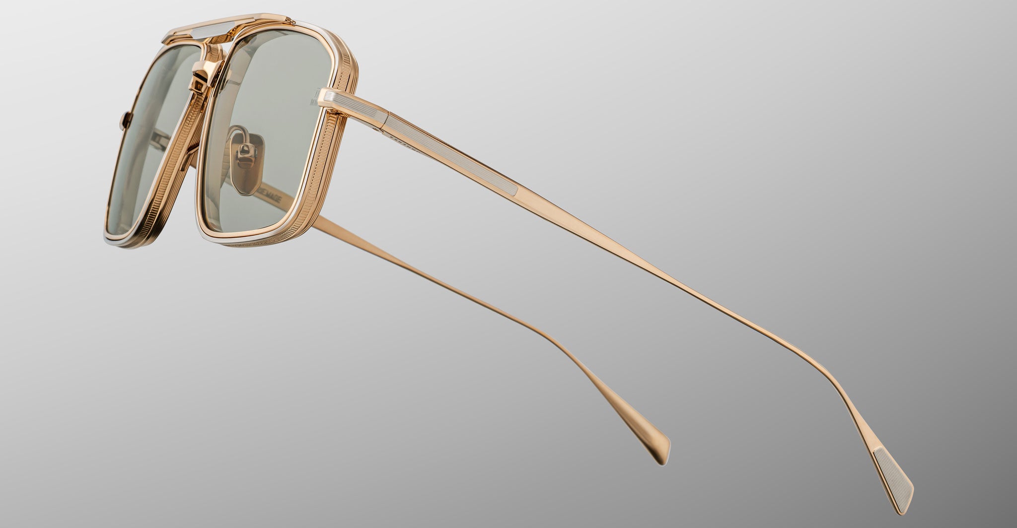 Jacques Marie Mage Earl rectangular sunglasses with gold frame and green lenses, shown from the side.