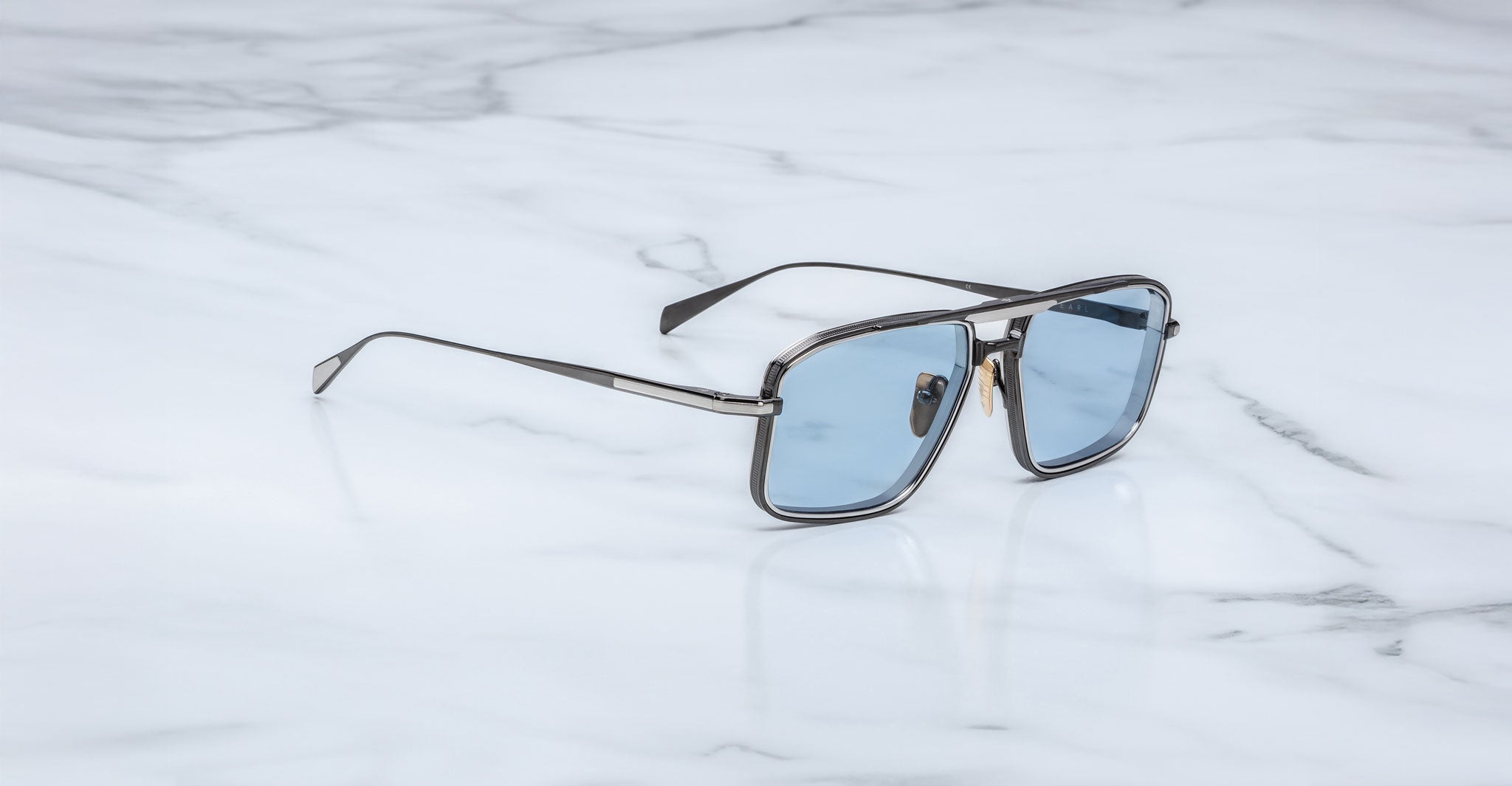 Jacques Marie Mage Earl aviator sunglasses with blue lenses, viewed from above.