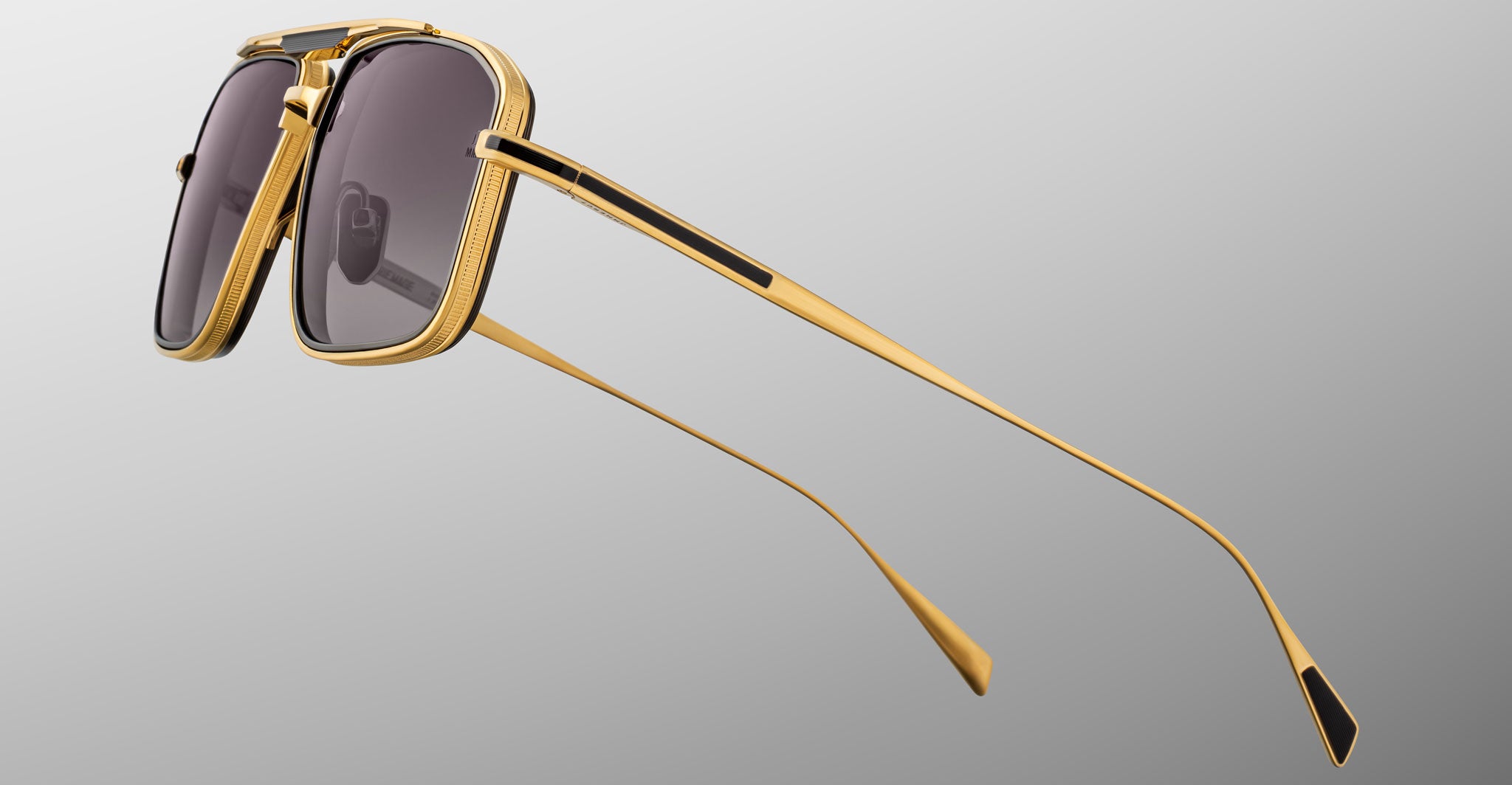 Jacques Marie Mage Earl sunglasses in gold and black with dark lenses, side view showing frame details.